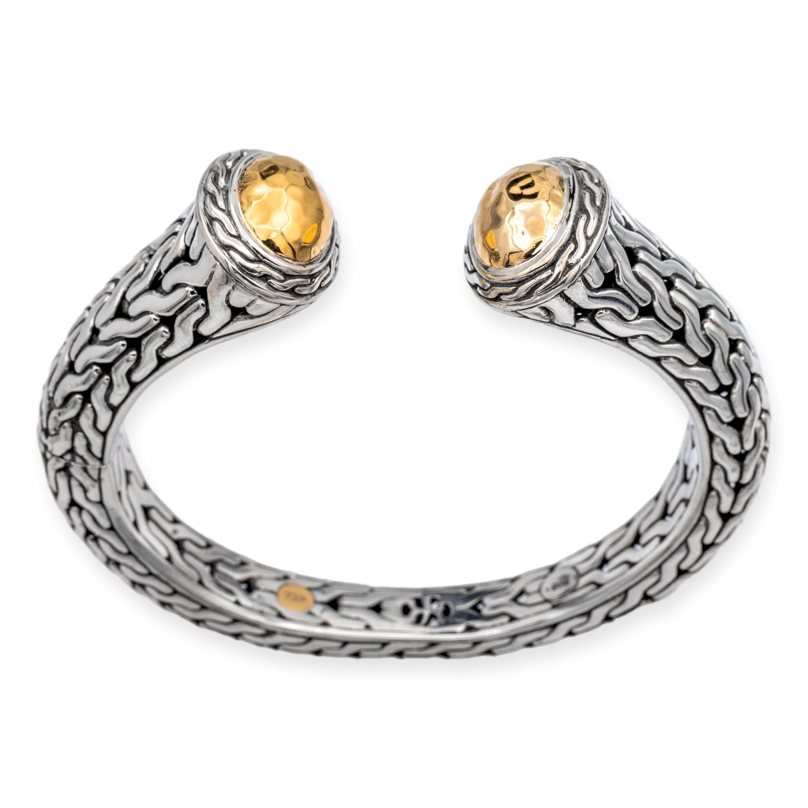John Hardy Palu hinged open cuff bracelet from the classic chain collection finely crafted in sterling siIver featuring two gold domes at each end with a hammer finish in 22 karat yellow gold inside a chain link bezel design. One end opens up for