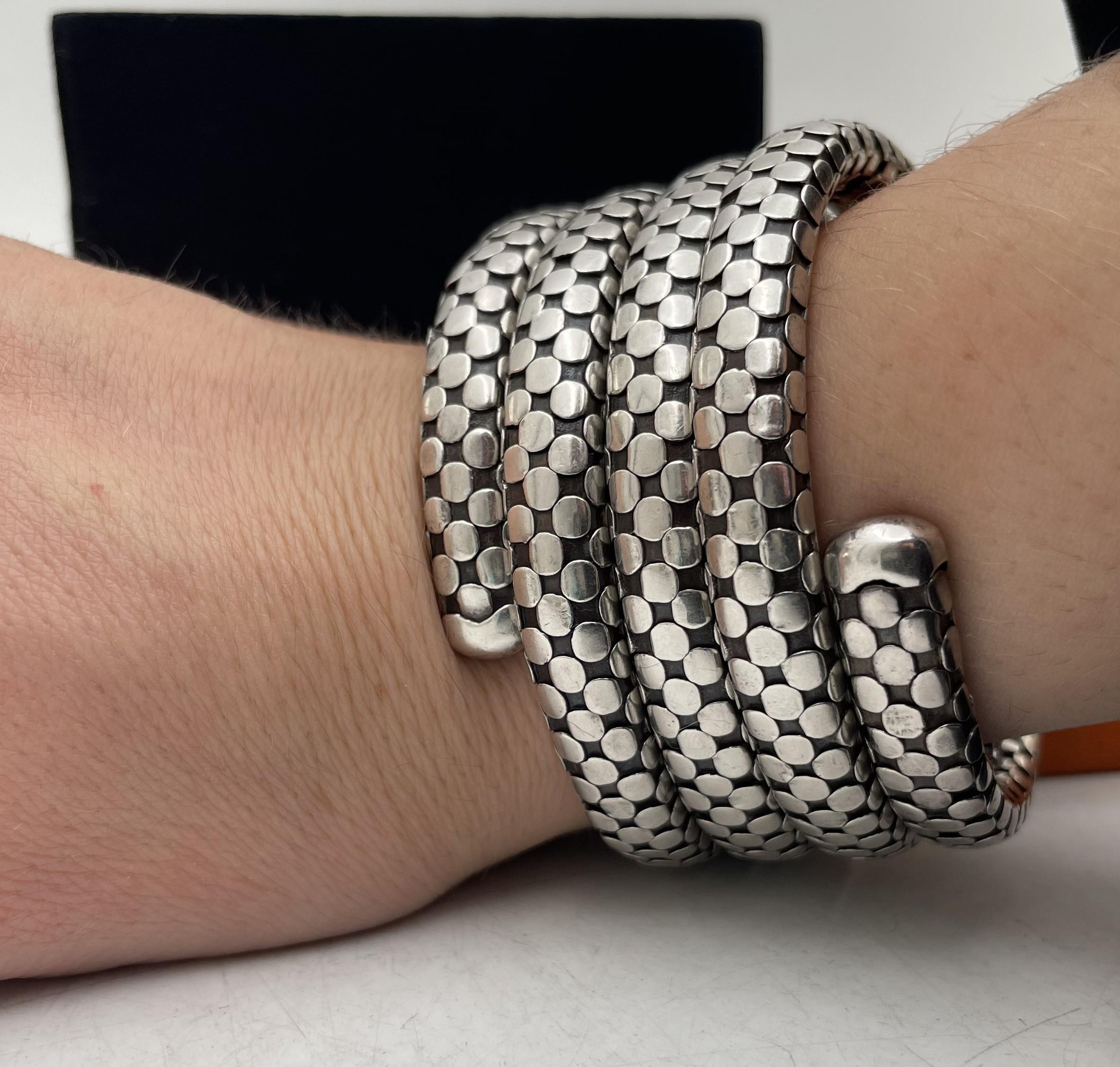 John Hardy sterling silver 4-coil dot flex wrap bracelet. It measures 2 1/4'' in expandable diameter by 1 3/4'' in height, is sold in its original box, and bears hallmarks as shown. 

Please feel free to ask us any questions, and please see our