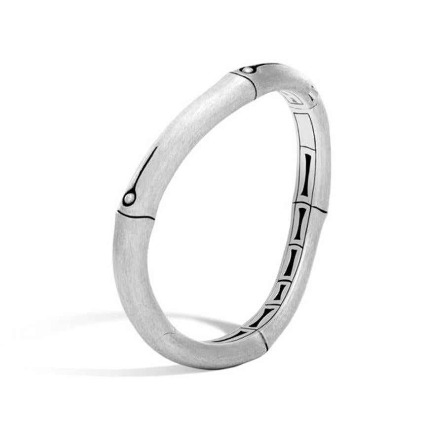 Simplicity and elegance are combined in this John Hardy bangle from the Bamboo collection. The bracelet features the smooth texture of bamboo segments with modest hand-carved designs. This sterling silver bracelet can be worn alone or paired with