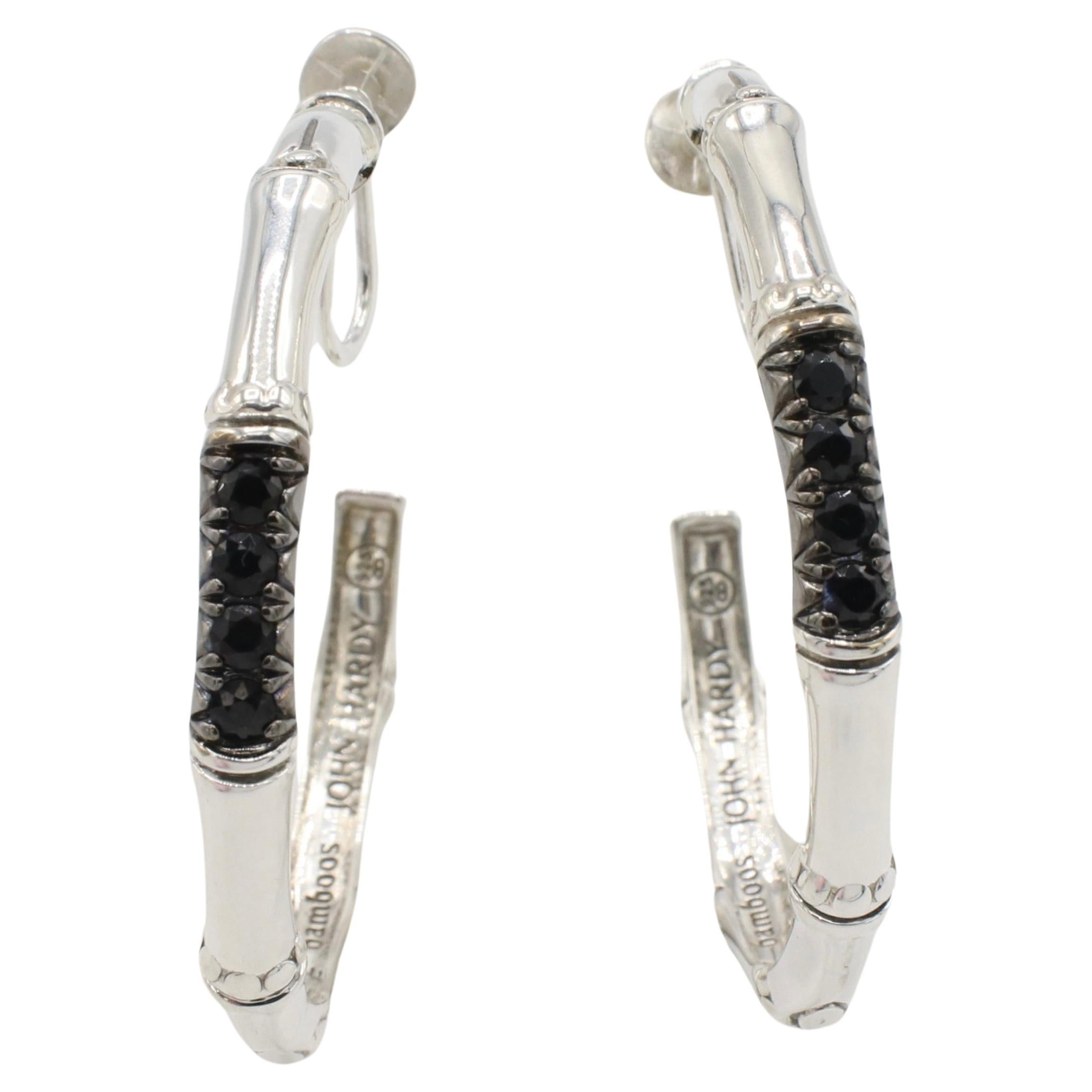 John Hardy Sterling Silver Bamboo Lava Black Sapphire Hoop Earrings 
Metal: Sterling silver 935
Weight: 8.7 grams
Width: 3.5-4mm
Inside Diameter: 35mm
Backs: Non-pierced screw clip on 
Signed: 