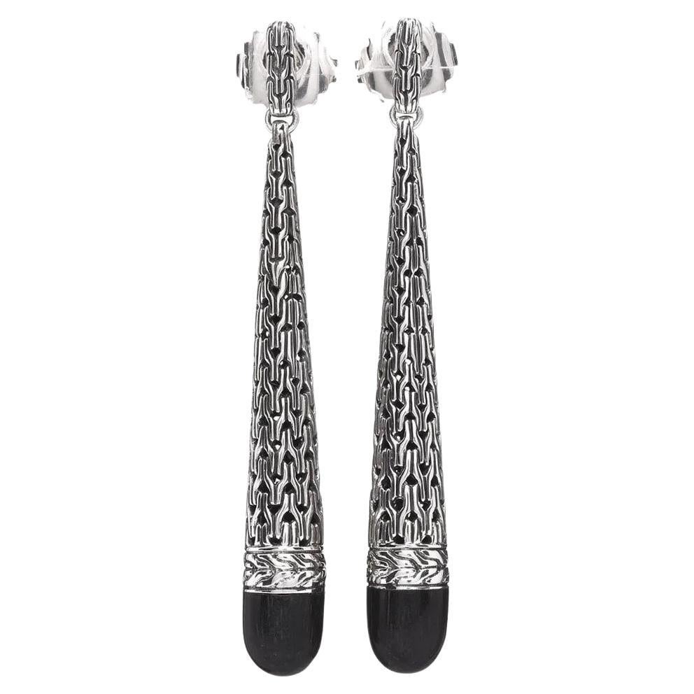 John Hardy's Drop Earrings feature sterling silver craftsmanship and black ebony wood, making them a classic addition to any wardrobe. 

Measuring 2.50 inches in length and 8.00 mm in width, these earrings offer a secure fit with post backs.

John