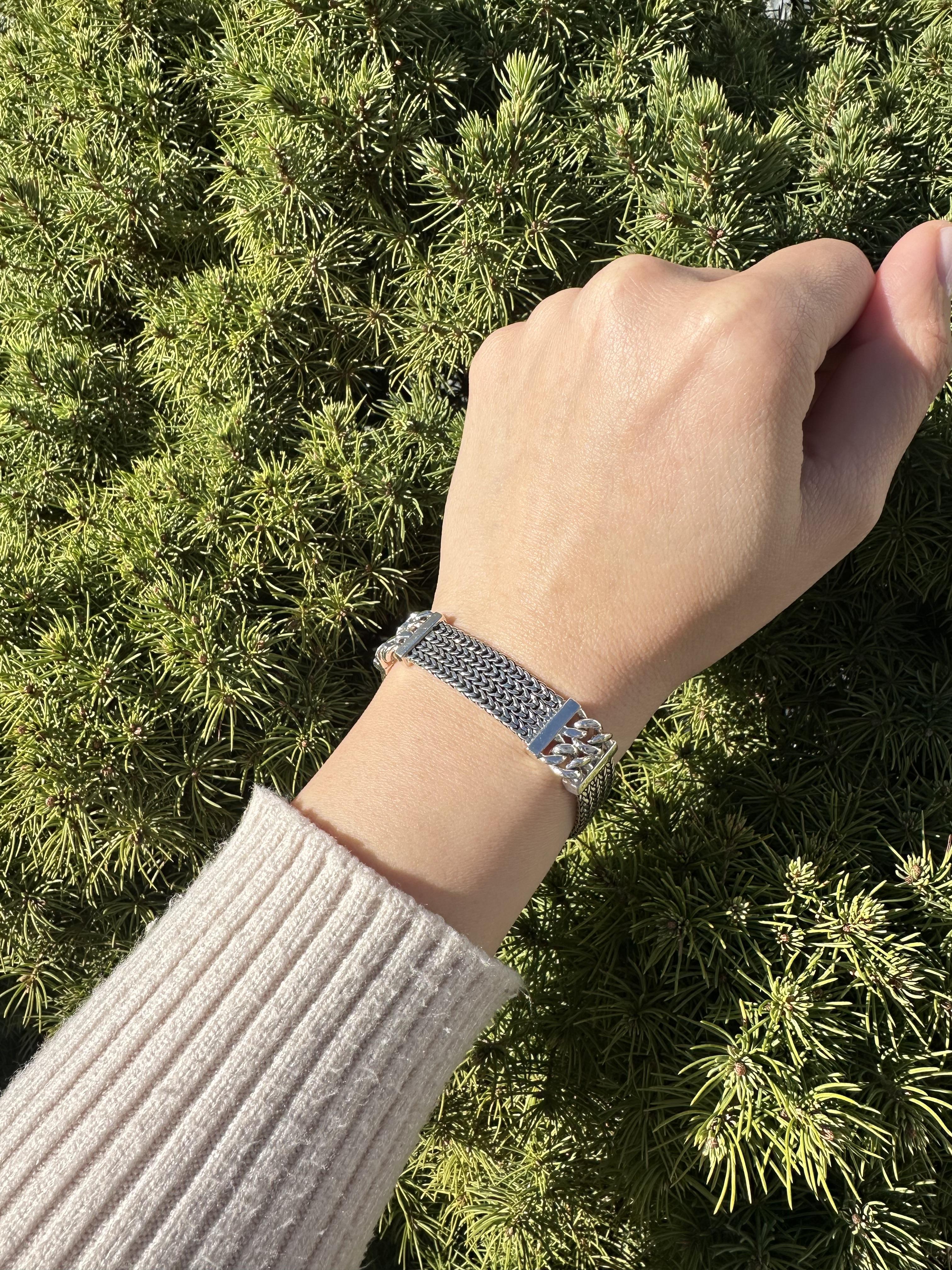 Material: Sterling Silver
Weight: 36.59 Grams
Chain Type: Weave Link w/ 2 Curb Stations
Chain Length: Measures 6.75 Inches Next to a Ruler - Will comfortably fit up to 6.25” wrist (fitted on wrist)
Closure: Push clasp
Width: 13.4mm (0.53