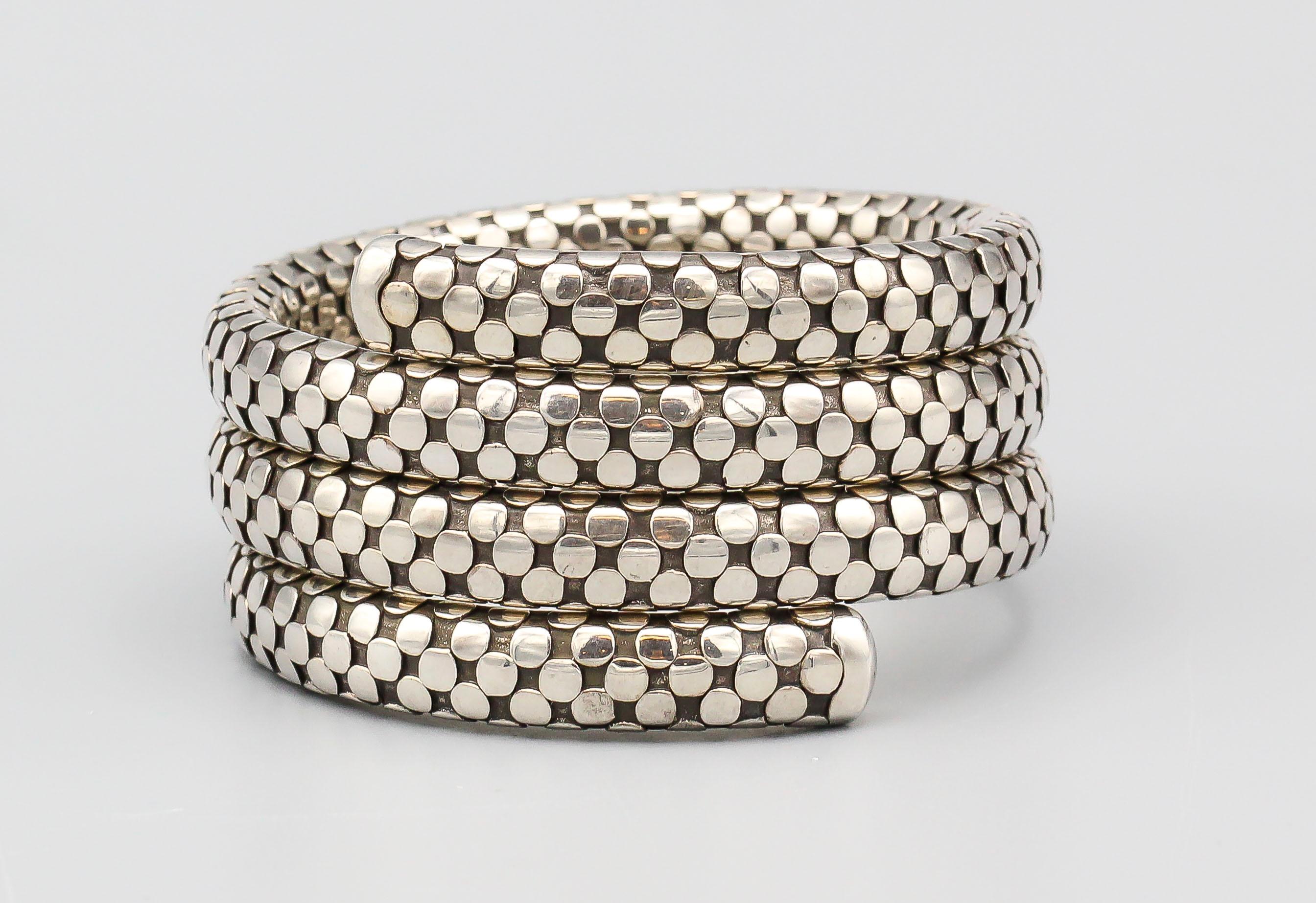 Introducing the John Hardy Sterling Silver Dot Coil Bracelet – a captivating and meticulously crafted piece that embodies the essence of artisanal excellence and contemporary elegance.

This exquisite bracelet is a testament to the iconic design