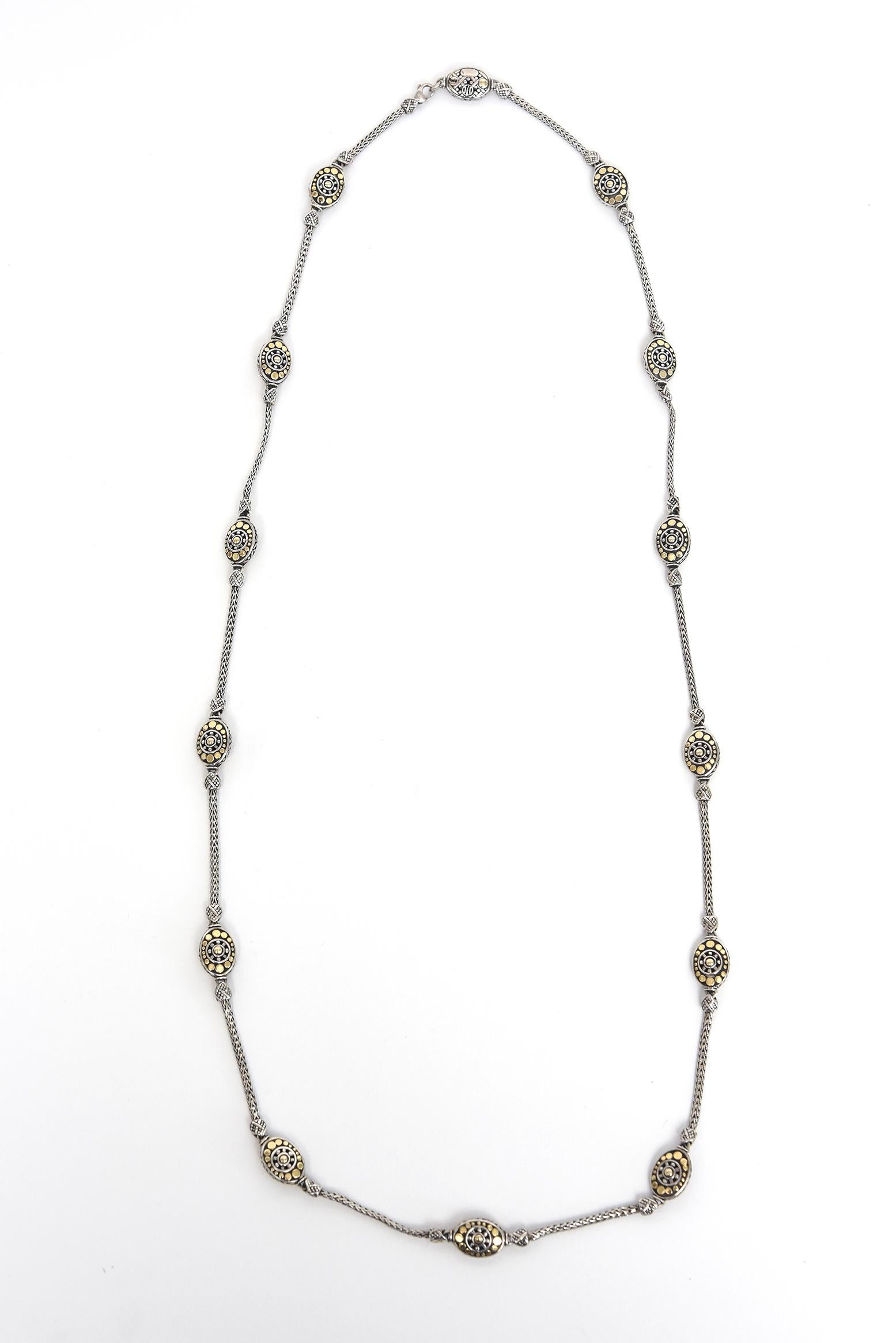 This rare extra long classic John Hardy Jaisalmer Dot Sautoir necklace is sterling silver with fourteen 11.57mm wide x 15.3mm (just the oval area) oval stations embellished with 18 karat yellow gold dots.  The sections are connected to each other by