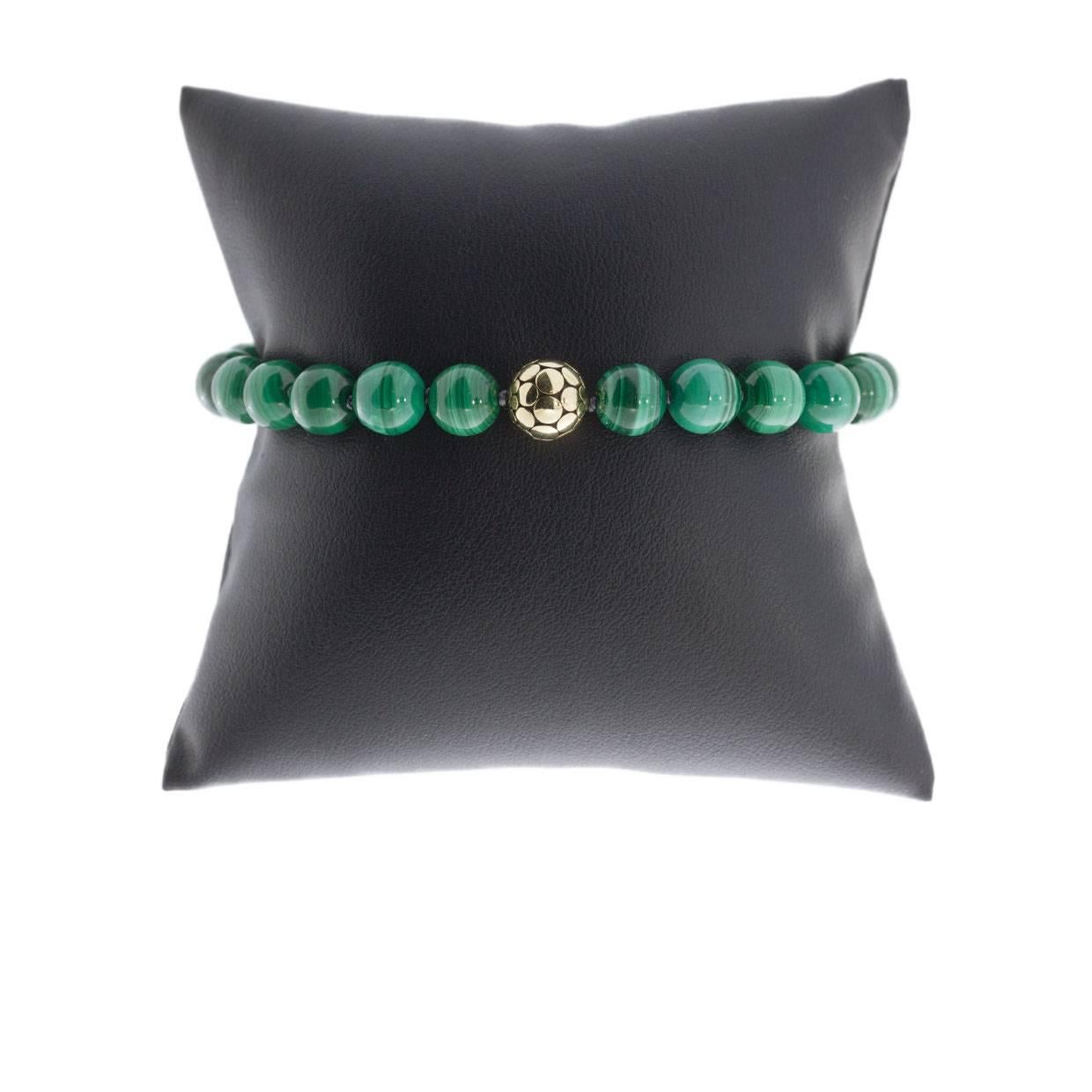 Each piece of John Hardy jewelry has been crafted in Bali since 1975. John Hardy is dedicated to creating timeless one-of-a-kind pieces that are brilliantly alive.

This sterling silver and 18K yellow gold malachite bead cord bracelet is from John