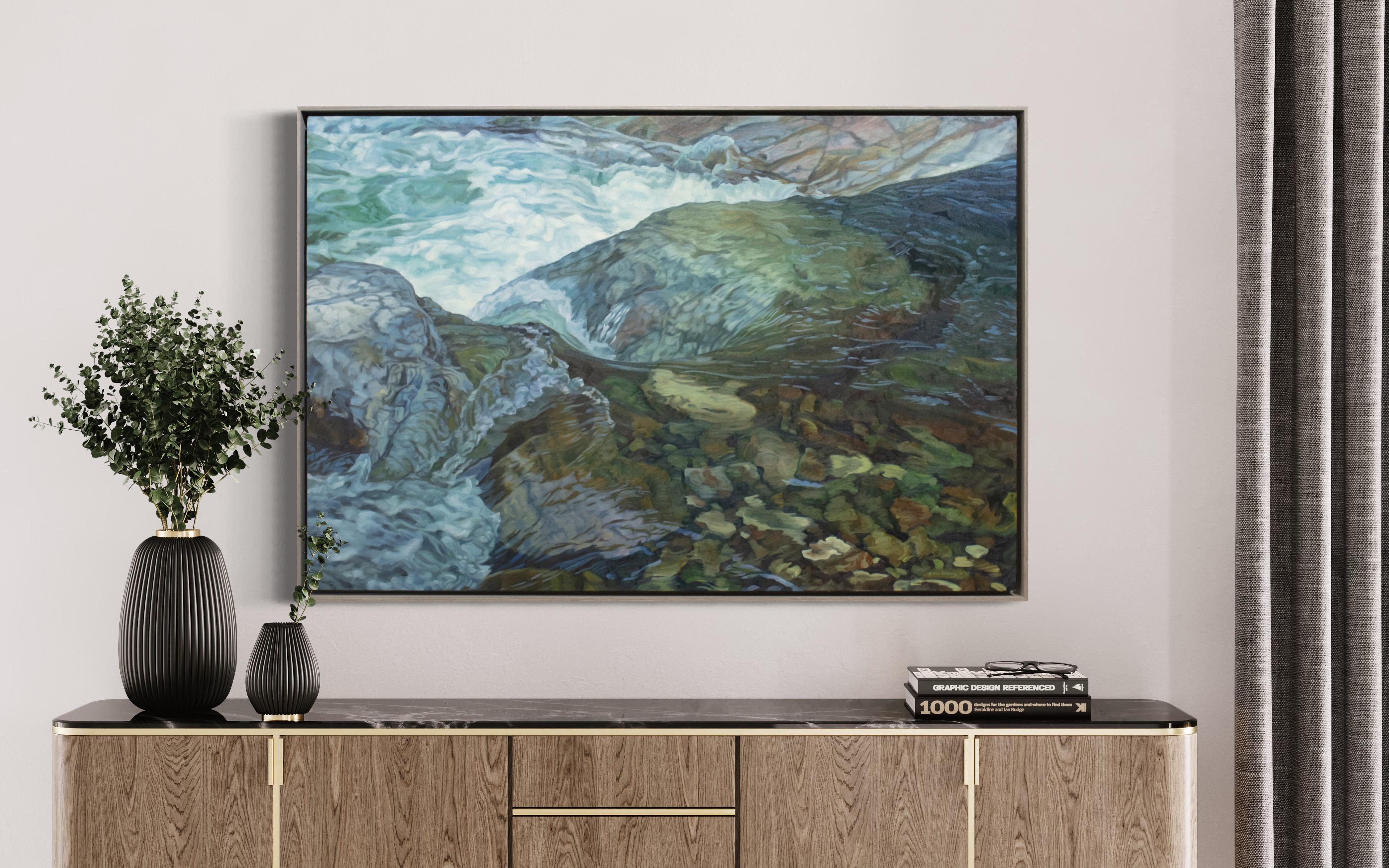 This naturalistic oil painting by John Harris features a cool blue and earth-toned palette and captures a close-up view of river water rushing over rocks on a riverbed. It is made with oil paint on on gallery wrapped linen canvas, and is framed in a