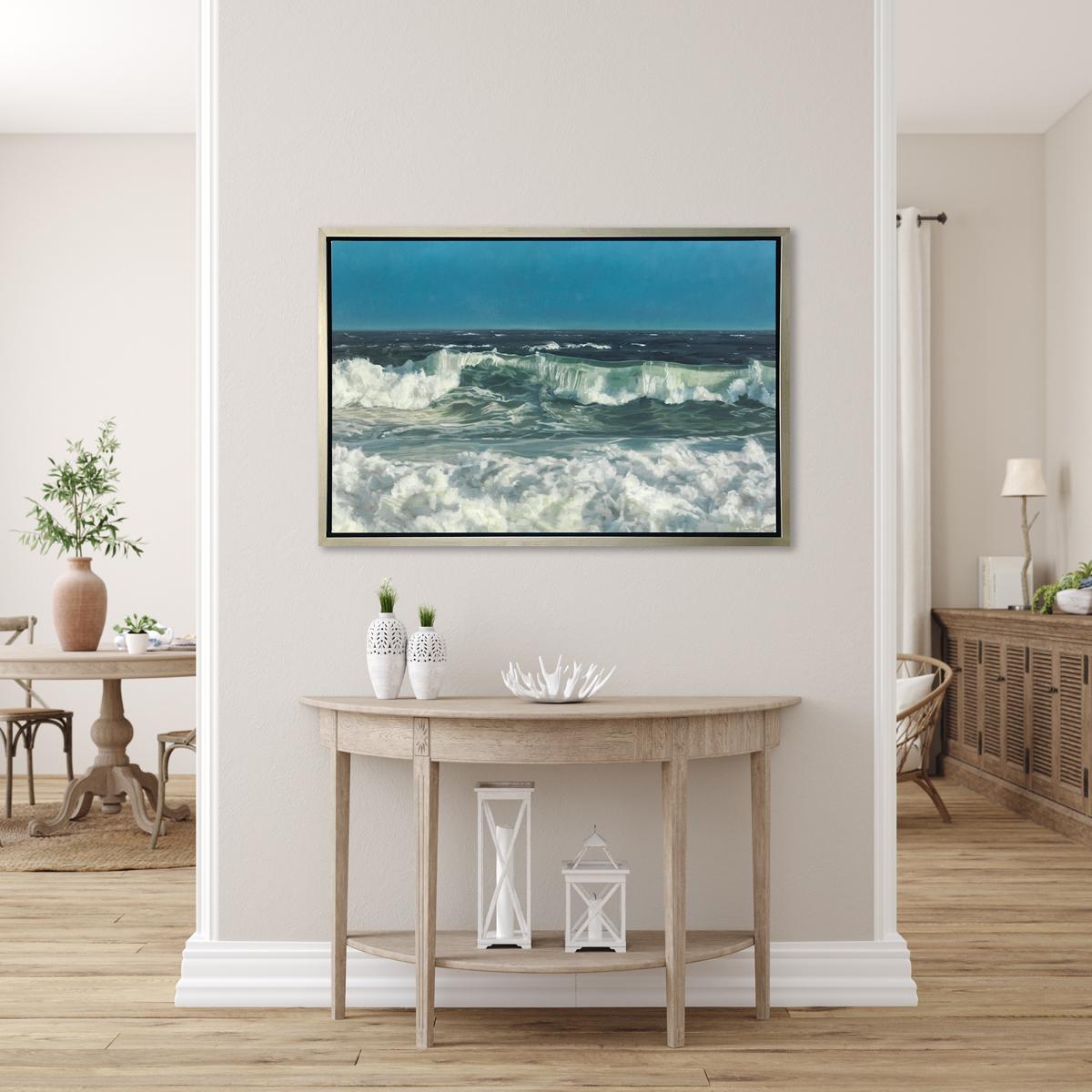 This limited edition seascape print by John Harris captures a highly detailed view of rolling ocean waves crashing near a shoreline under a clear blue sky. It features a mix of cool blue and sea green tones, highlighted by the white mist and foam of