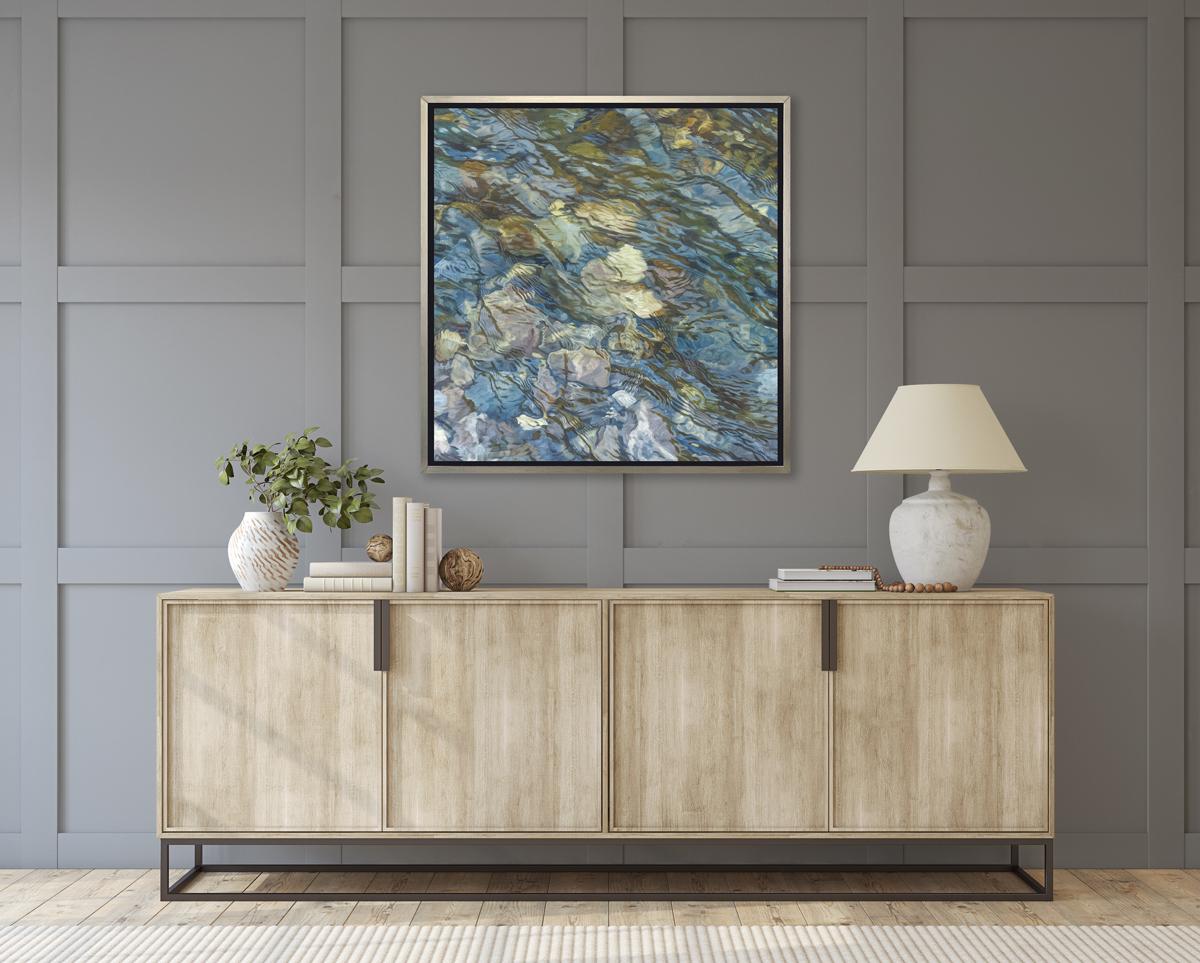 This realistic limited edition print by John Harris captures a close up view of water rippling over rocks in a riverbed. Natural light reflects off the surface of the water, enhancing the movement within the piece.

This Limited Edition giclee print