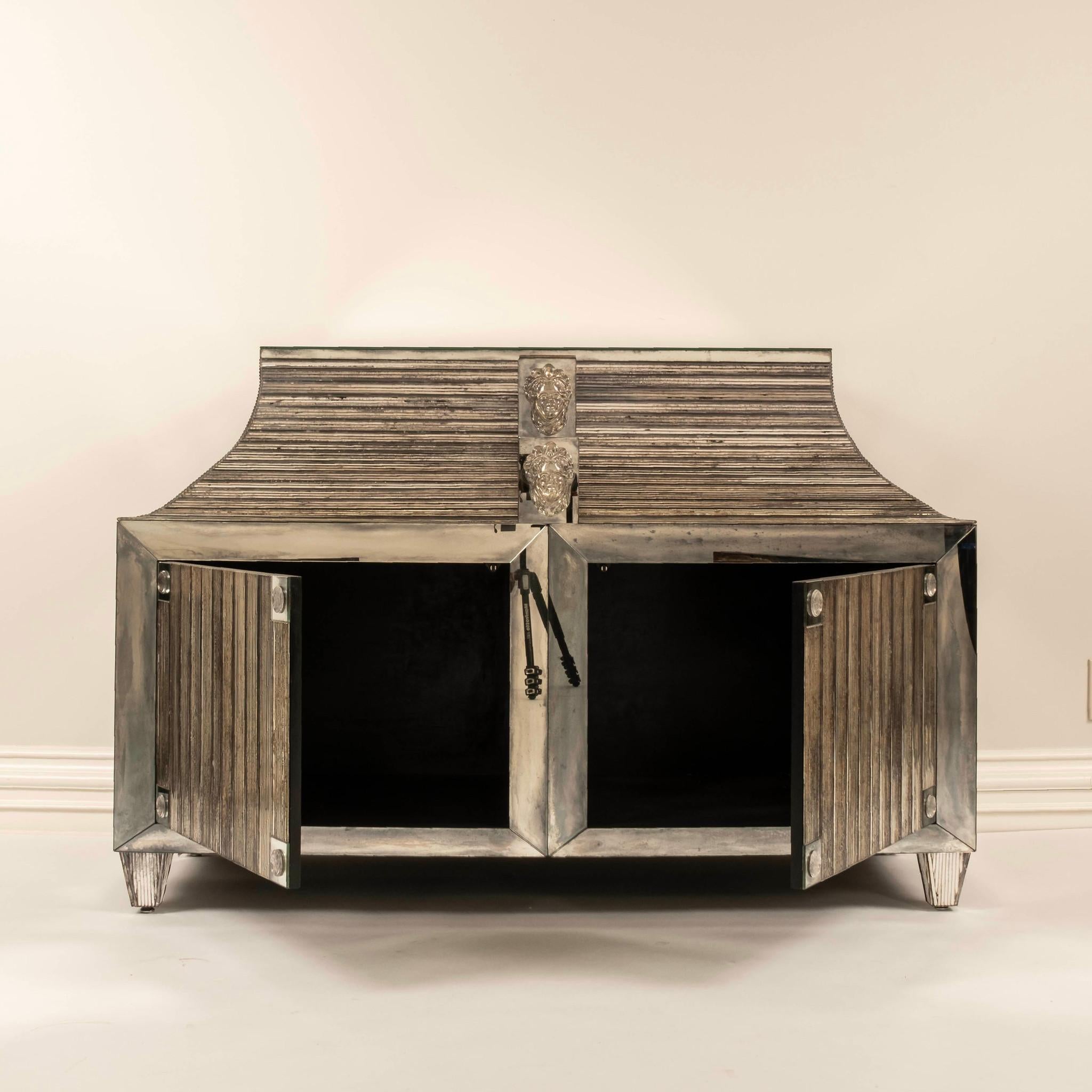 John Himmel Reeded Mirror Neoclassical Style Cabinet composed of  reeded and antiqued glass mirror. This magnificent two-door cabinet features two hand blown glass face medallions.