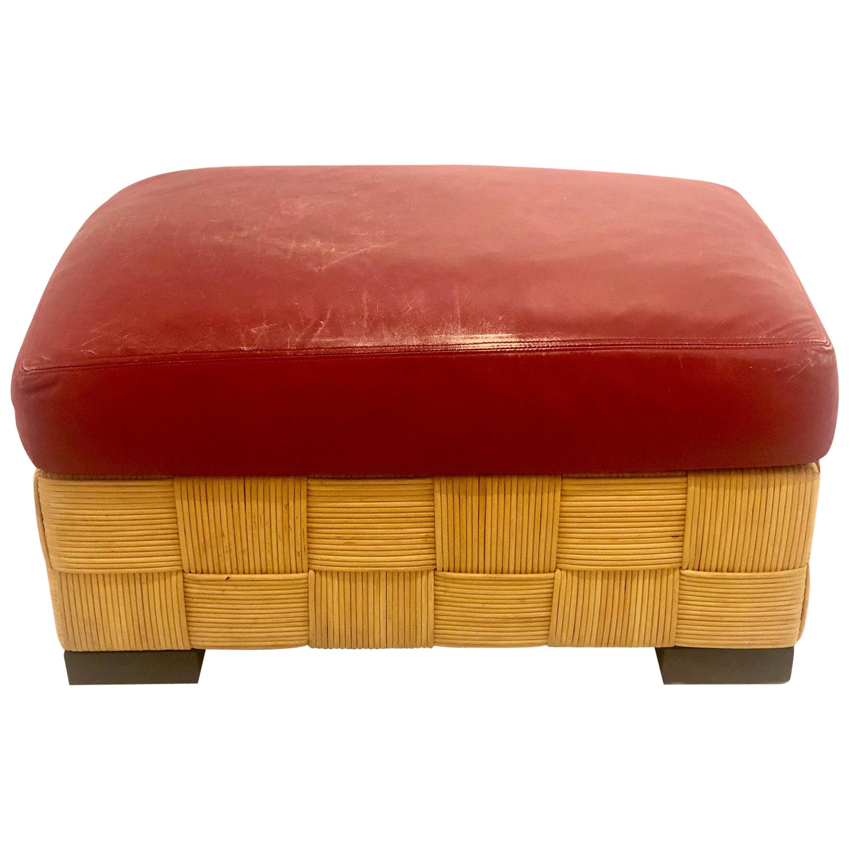 Wonderful designed, these Island inspired wicker ottomans by John Hutton, are heavy and well constructed. With nicely worn red leather cushions and dark walnut finish feet, incredible construction and quality, the cushions are nicely worn as seen on