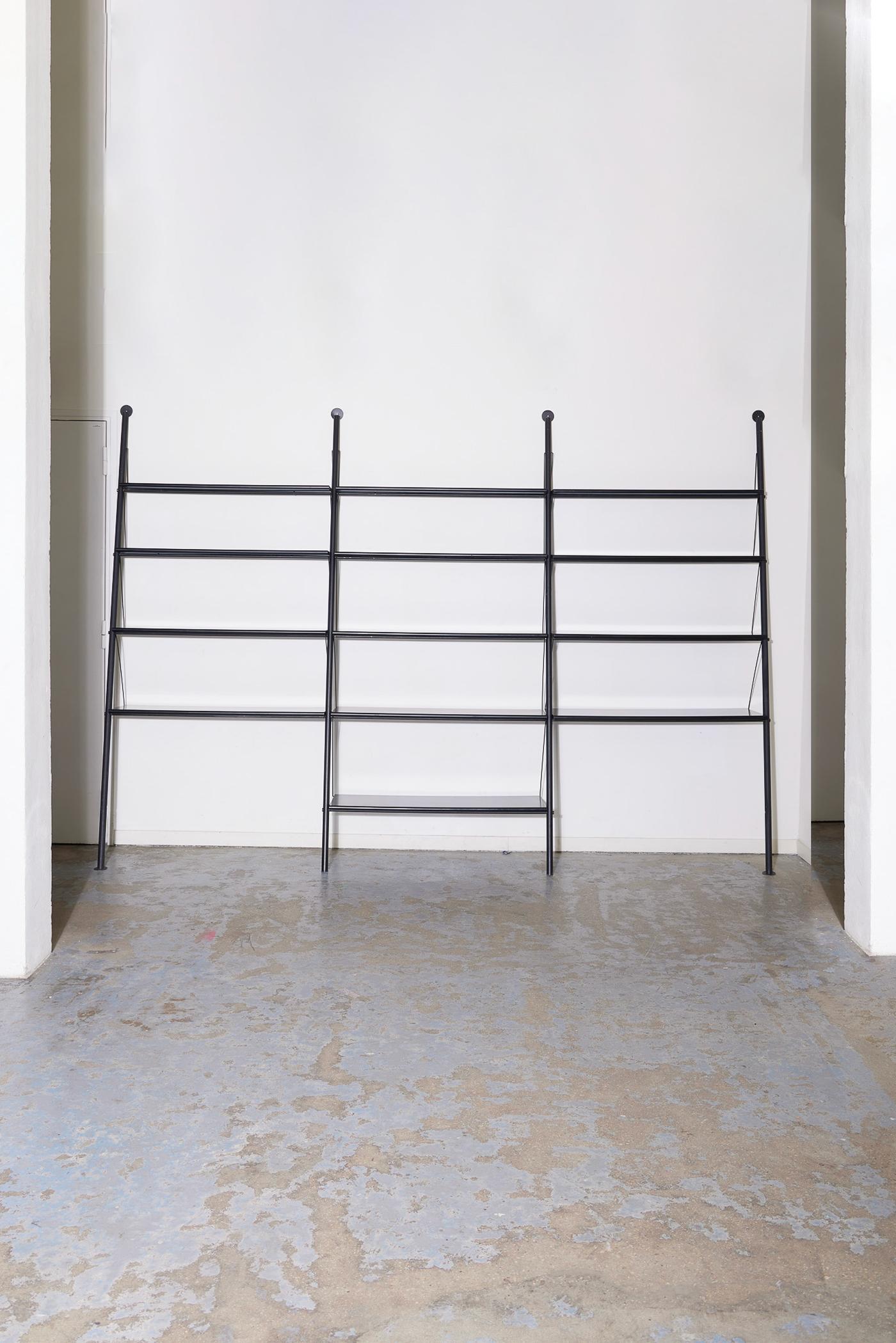 Shelf model 'John Ild' by designer Philippe Starck, published by Disform in the 1980s (1982). The structure consists of two black tubular metal uprights and metal shelves. This is the first bookshelf model designed by the designer. In perfect