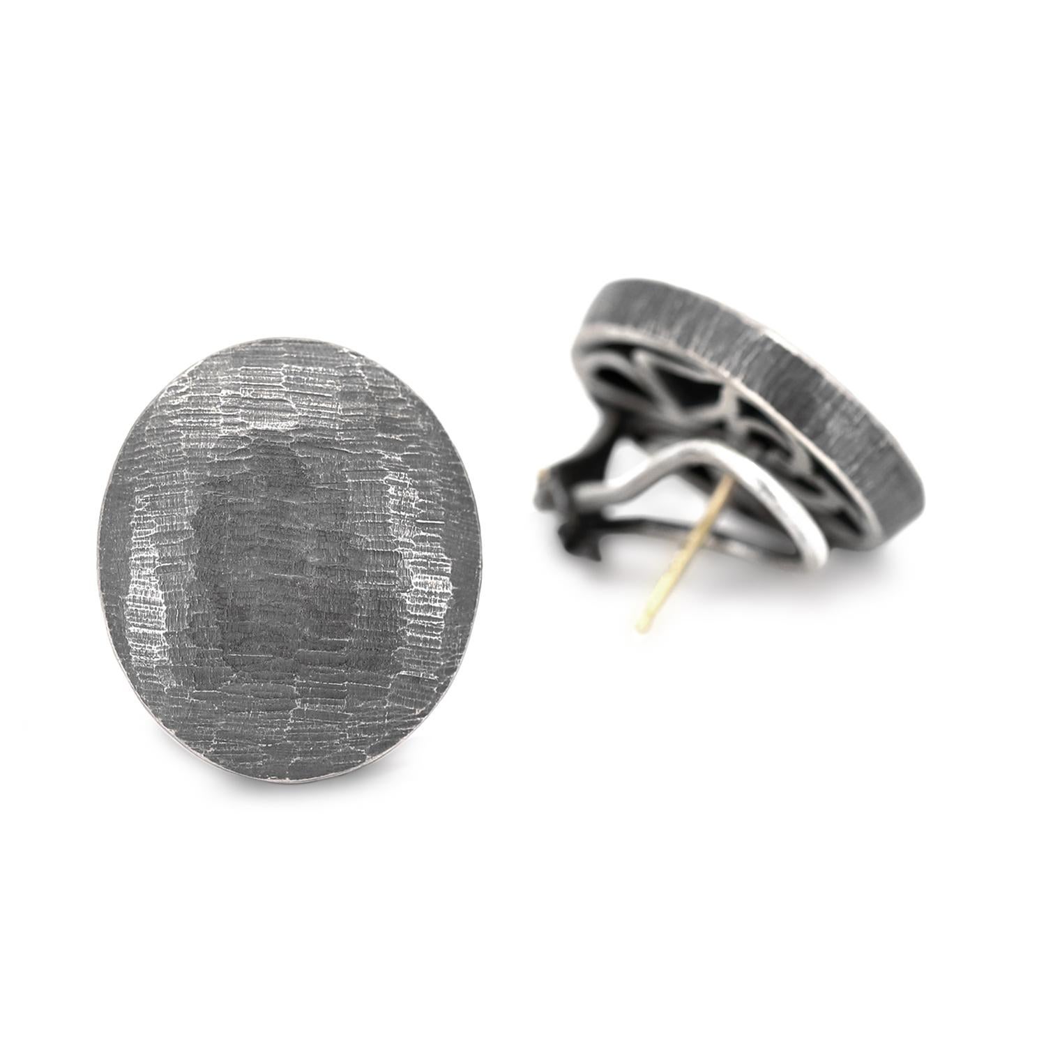 Large Oval Stud Earrings handcrafted by award winning jewelry maker John Iversen in finely-textured oxidized sterling silver with post and clip backs. Posts easily removed upon request. Stamped and Hallmarked.

About the Maker - John Iversen has had