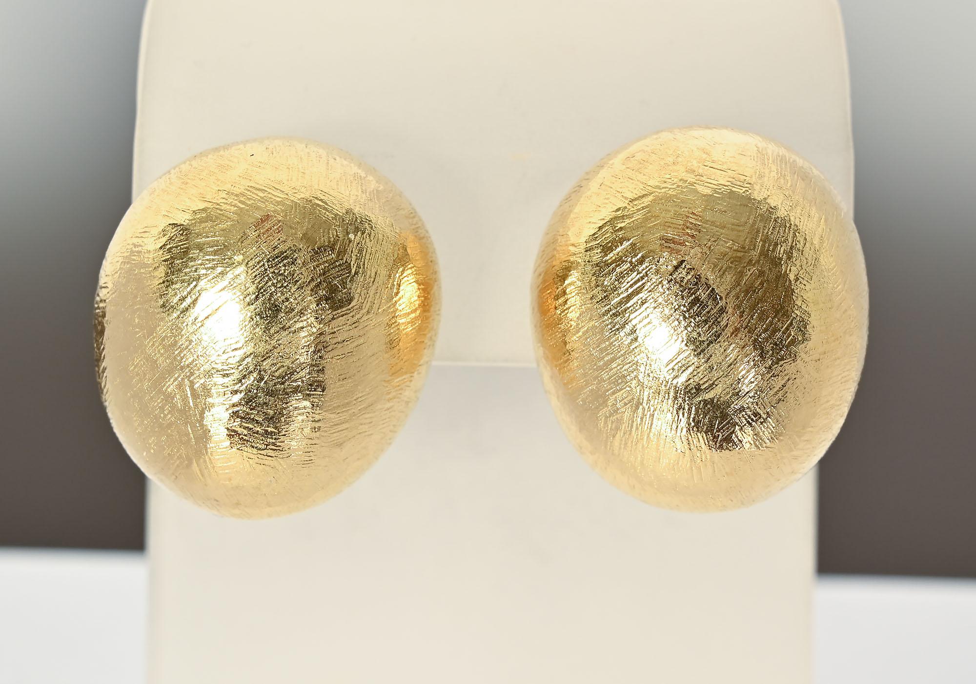 Gutsy domed earrings by John Iversen. The earrings are half an inch tall and have a wonderful  hand scratched surface. Backs are posts and clips but can be modified to either one alone. This is a simple design but the size, shape and texture give it