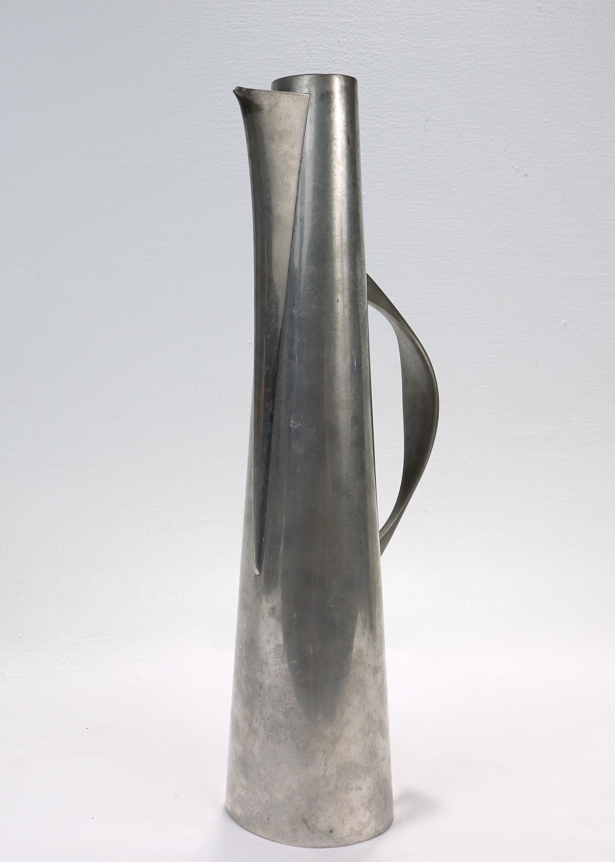 A fine Modernist pewter pitcher or ewer.

By John 'Jack' Prip.

In the form of a narrow, tapering pitcher with an integral handle.

Prip, a master metalsmith, is an extremely important figure in the history of American metalsmithing. Prip was