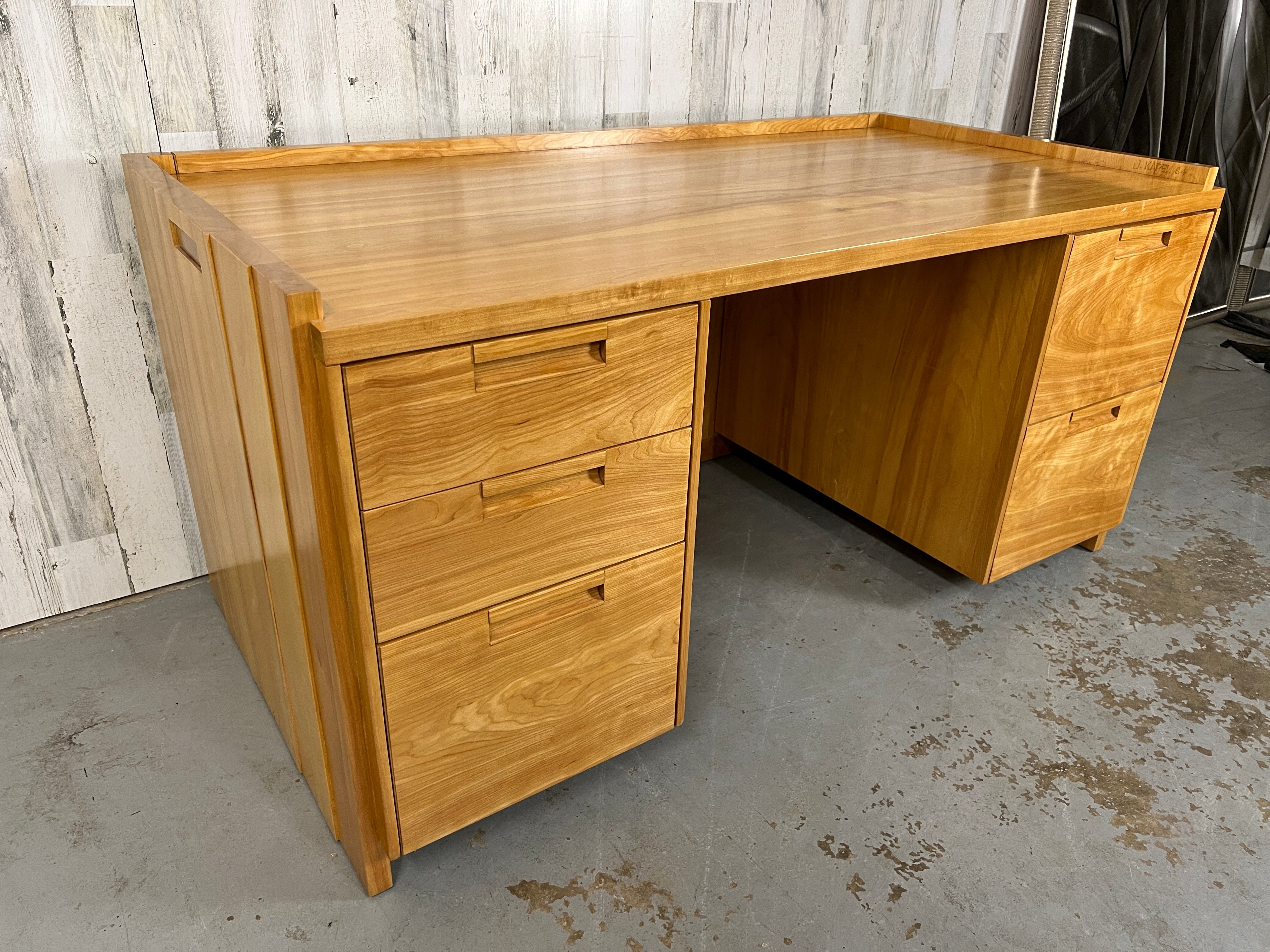 Very Rare Custom Made John Kapel Sculpted Cherry Wood Desk. Incredible wood grains. Very sturdy and solid. This desk is very unique and hard to come by. As pictured- John Kapel making this desk custom back in the day. 
Writing surface height: