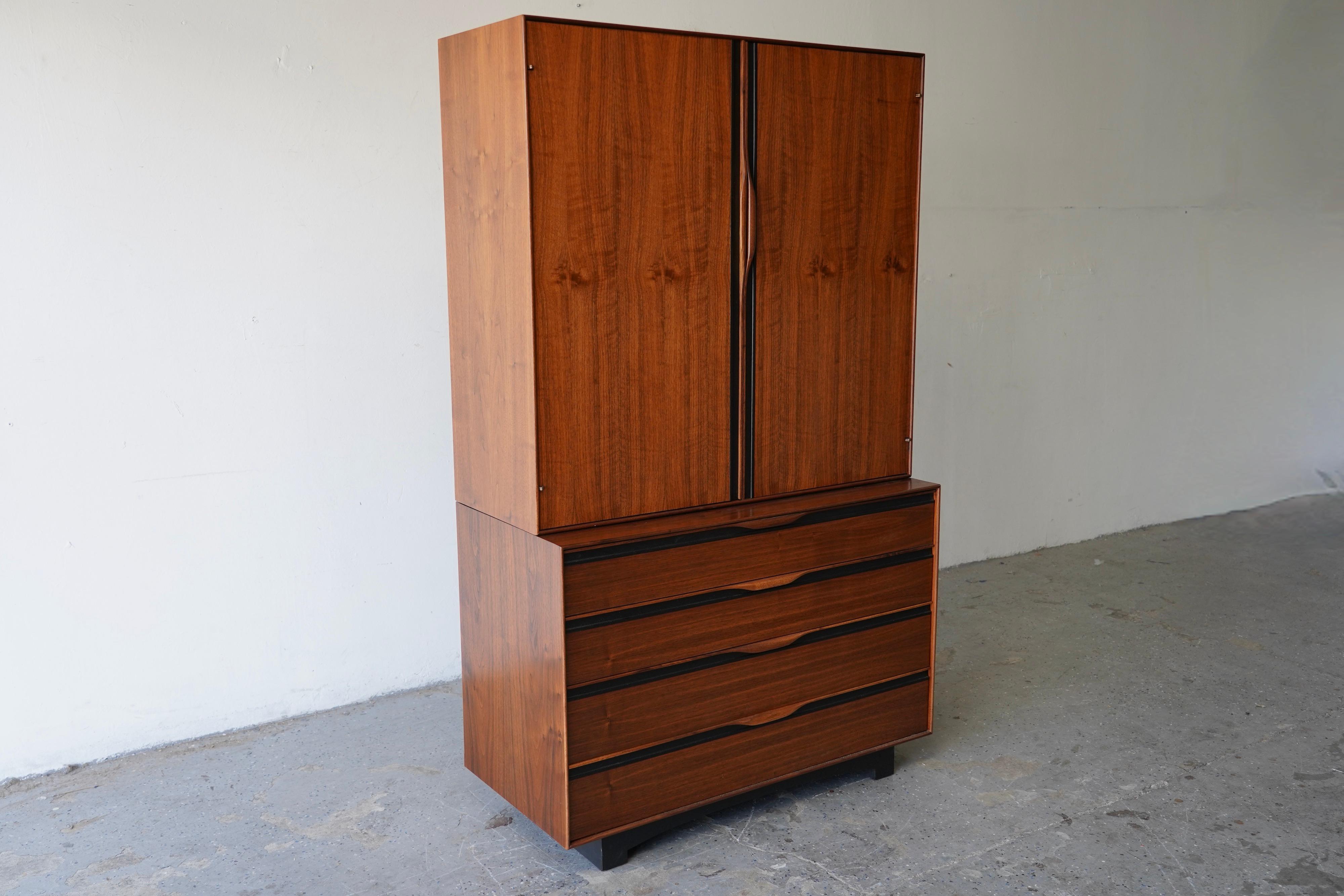 This distinguished by John Kapel for Glenn of California dresser features a streamlined design with exceptional craftsmanship and premium materials. Notable elements include elegantly sculpted handles, refined black trim, and a subtly curved