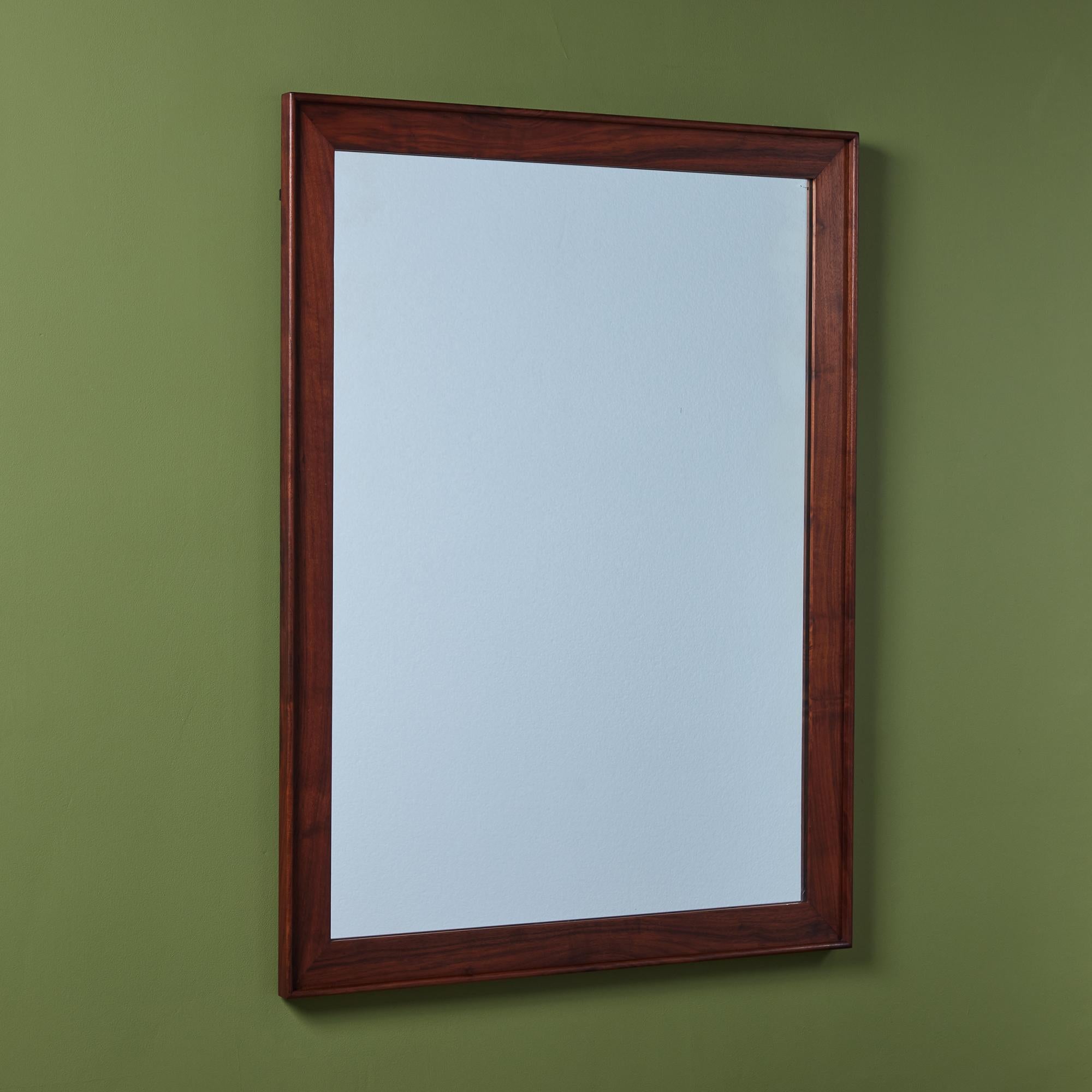 Walnut mirror by T.H John Kapel, manufactured by Glenn of California c.1960s, USA. The rectangular wall mirror can be hung either vertically or horizontally.

Dimensions
42
