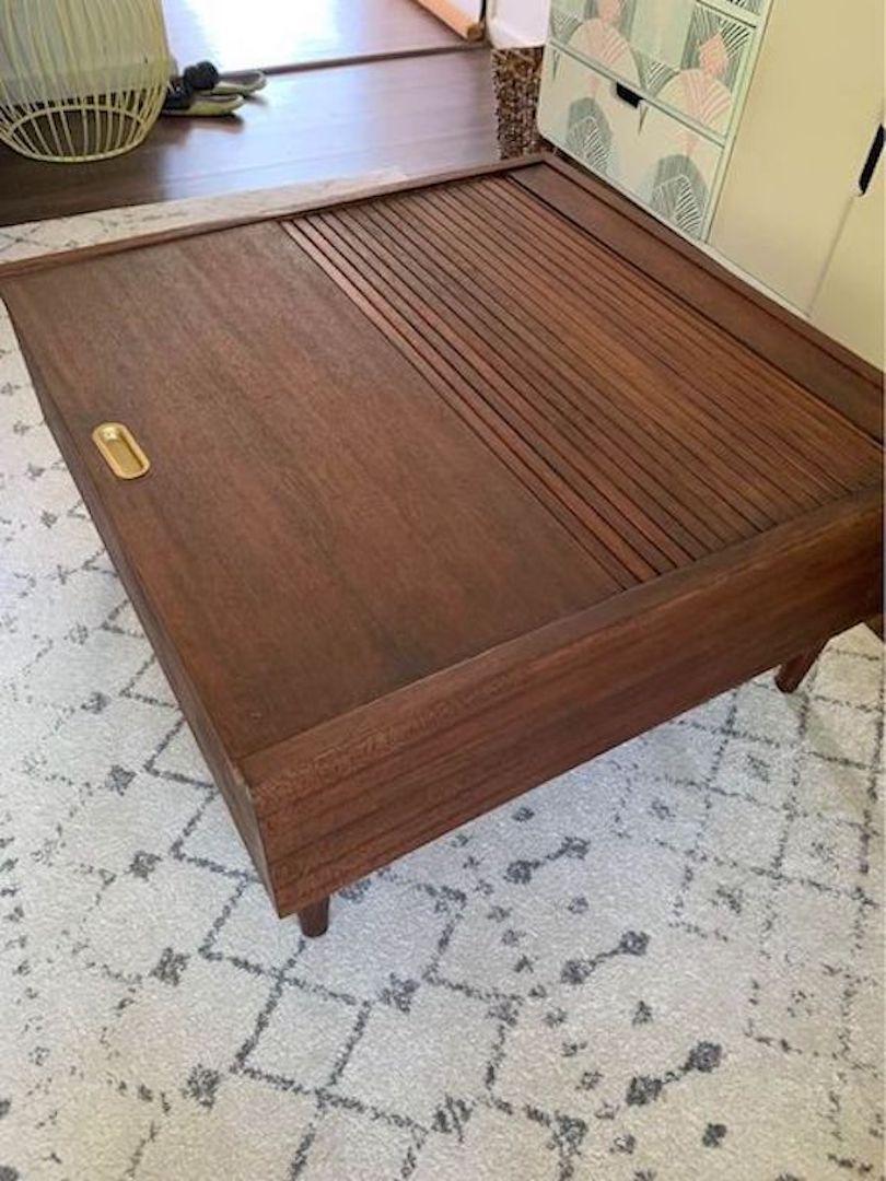 The Brown Saltman mid century coffee table was designed John Keal in the 1950's. This mahogany coffee table has a tambour sliding door and storage inside.
Shipping Free Only on Long Island
Height: 17 in. (43.18 cm)
Width: 32.25 in. (81.92