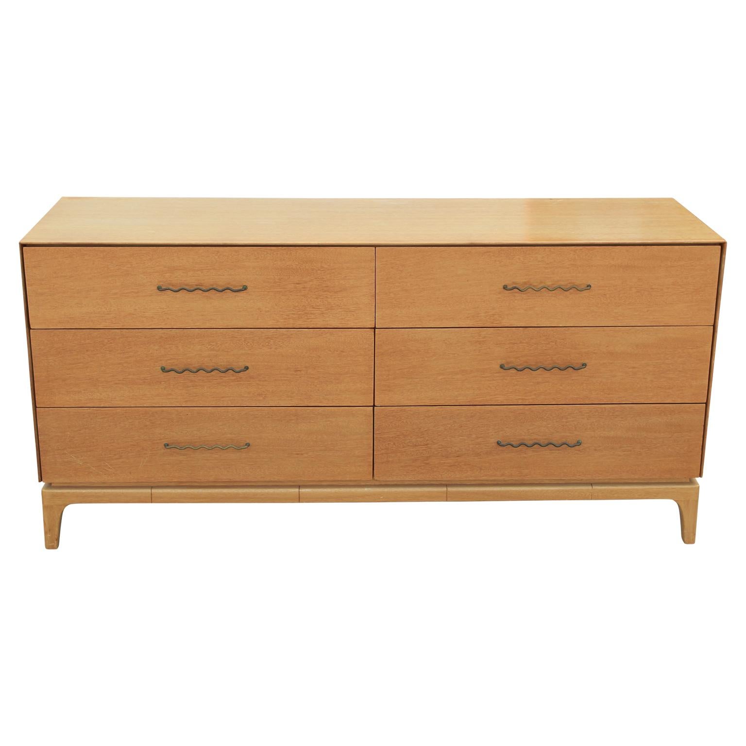 Mid-Century Modern mahogany sideboard/dresser by John Keal for Brown Saltman. There are six drawers accented with beautiful sculptural brass pulls. The piece has interesting line motifs on the base and is in original condition but can be refinished