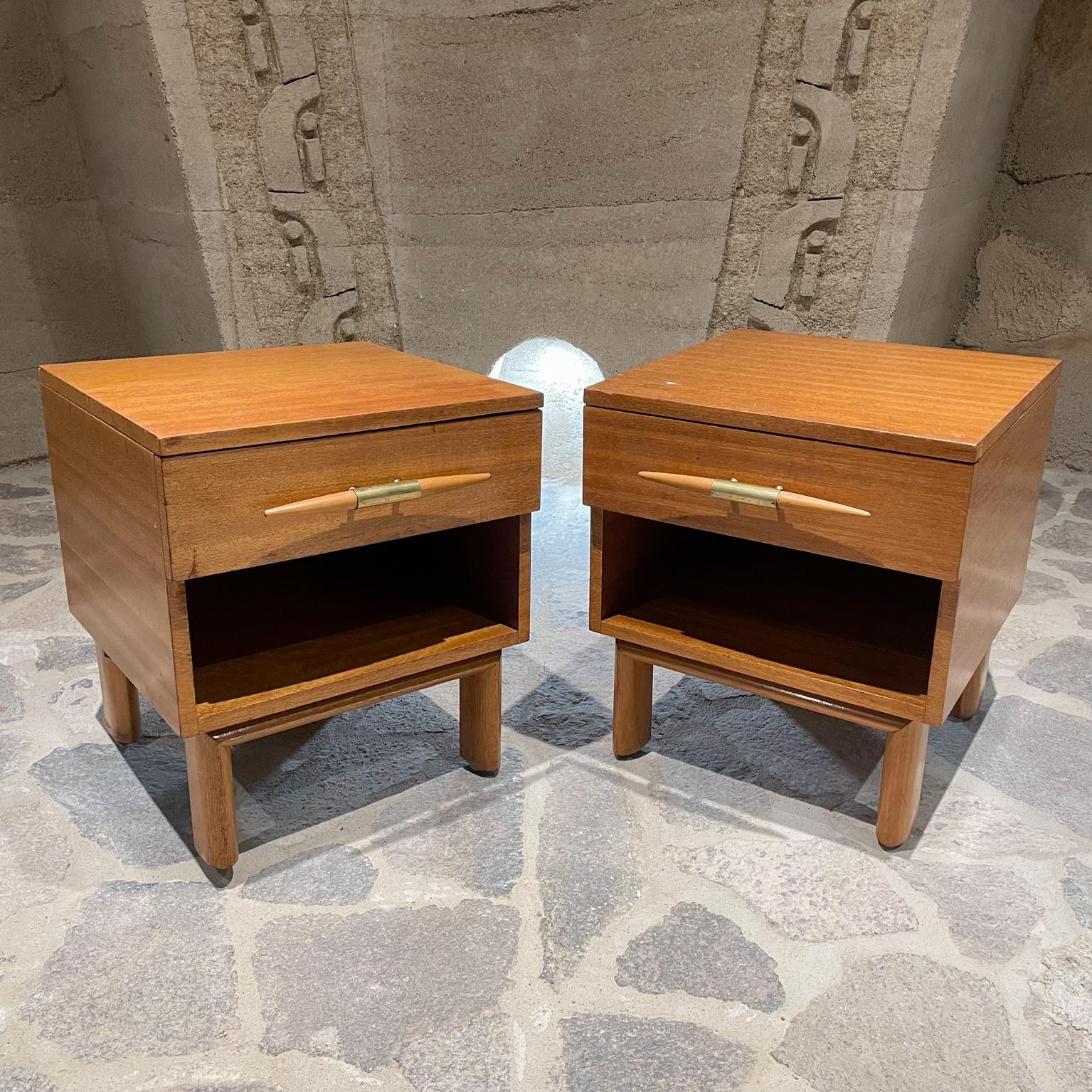 Nightstands
Brown Saltman blonde mahogany modern nightstands 1950s USA
Exceptionally clean modern lines designed by John Keal
Maker label present.
Shows sculptural thick oval legs and large spindle pulls with brass. 
Spacious drawer and