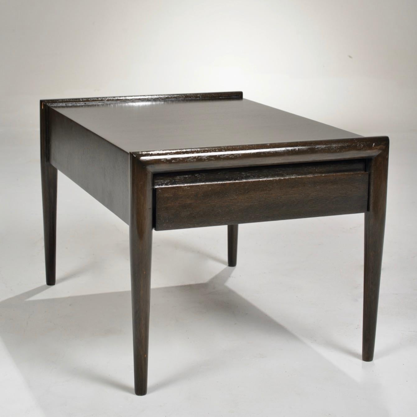 A mahogany side or end table with a drawer and on tapered legs. Designed by John Keal for Brown Saltman, circa 1950, with maker's mark on the inner drawer.




               