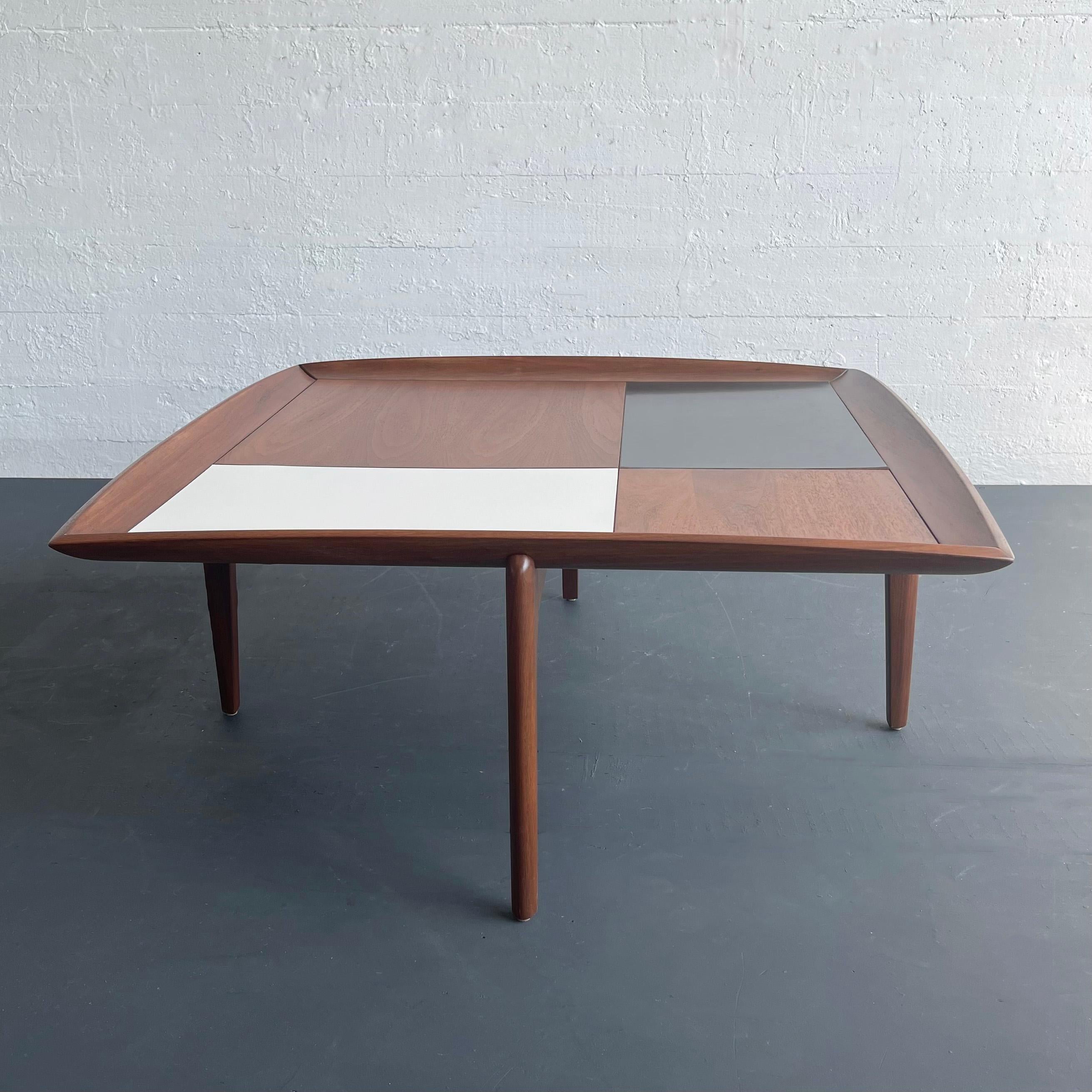 Gorgeous, mid-century modern, square walnut coffee table by John Keal for Brown Saltman features a top of checkered black and white laminate inlays with alternating walnut panels.  The upturned edges and sculpted legs give the table a tray