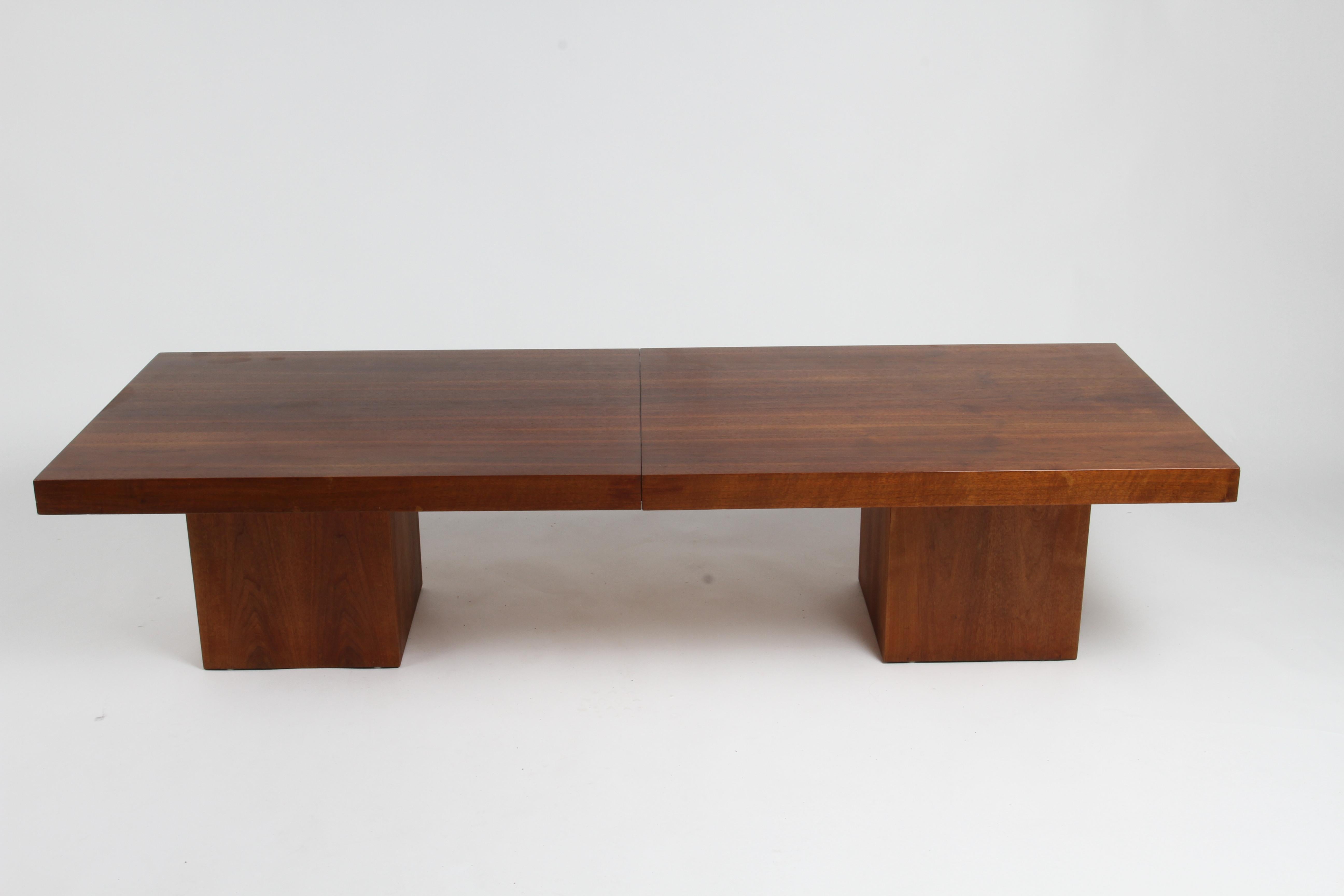 John Keal for Brown Saltman Mid-Century Modern rectangular walnut expanding cocktail table, with vinyl laminate center on block pedestals expands from 66