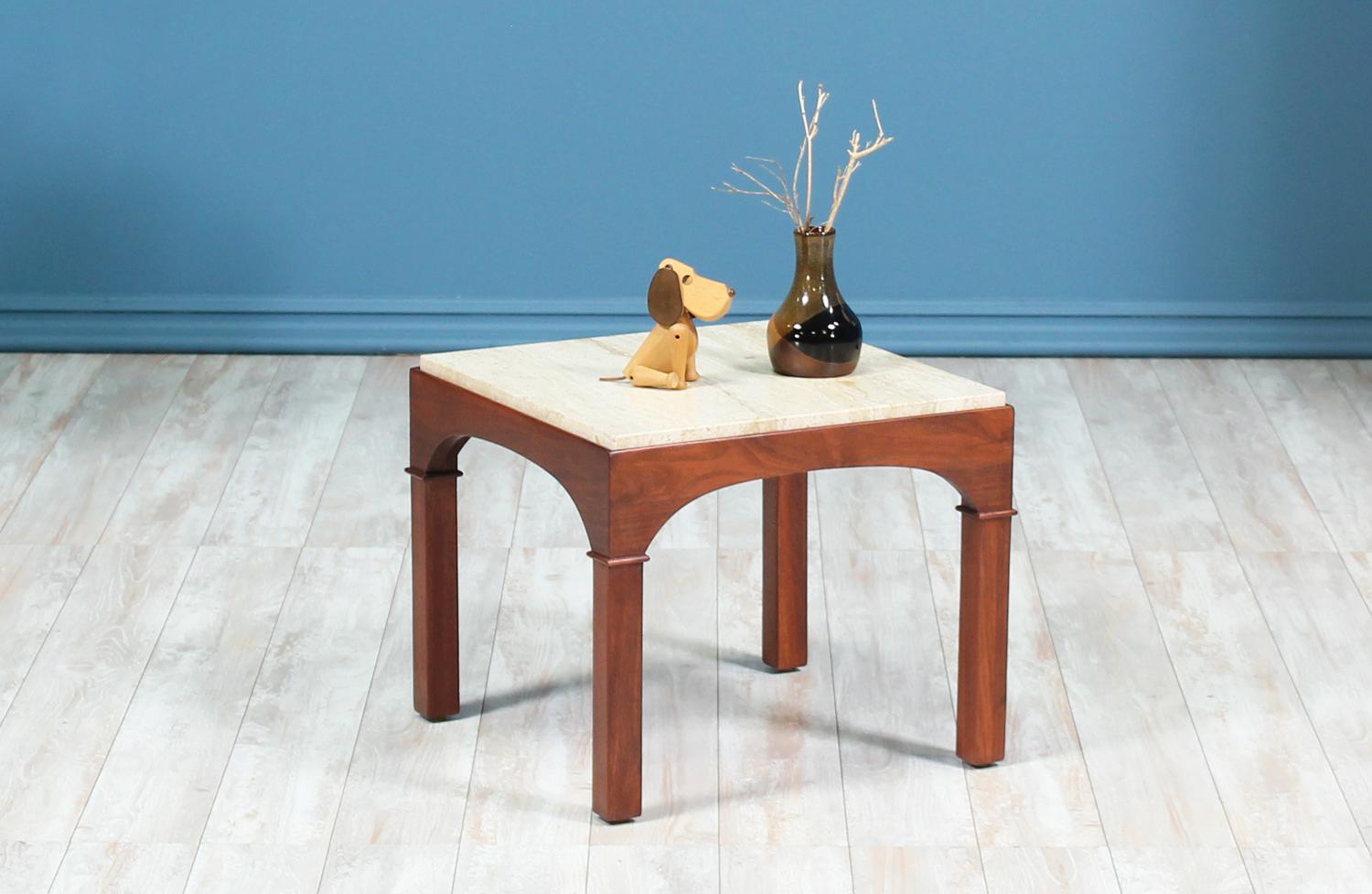 Stylish side table designed by John Keal and manufactured by Brown Saltman in the United States circa 1950’s. This unique design has been recently refinished by our skilled team of craftsmen and features its original travertine top in mint condition