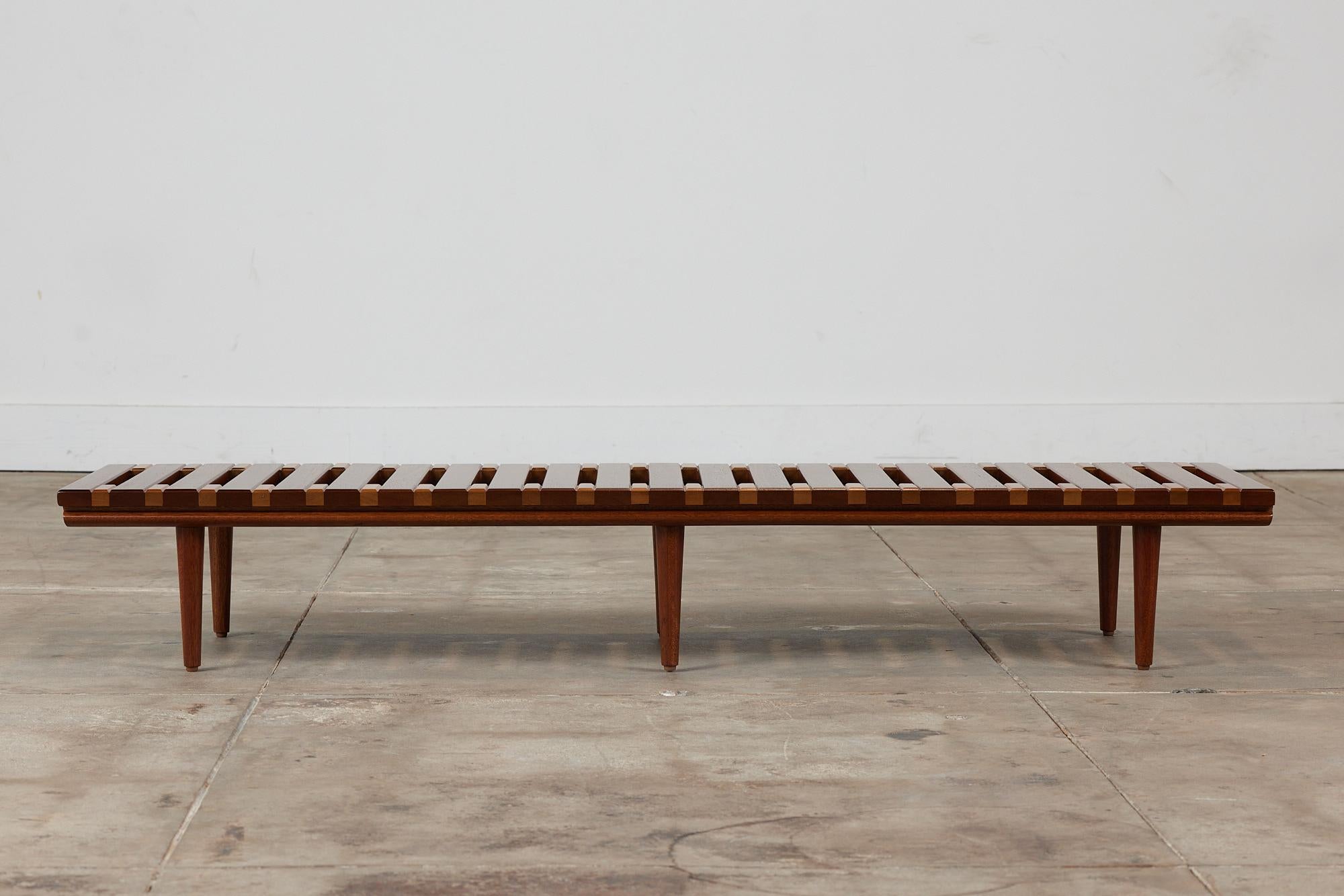 Low profile bench by John Keal for Brown Saltman, circa1950s, USA. The bench features a mix of mahogany and beech wood that offers texture and depth with varying wood tones. Perfect as a low profile coffee table, entryway bench or placed behind a