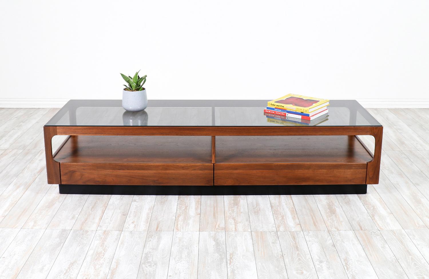 John Keal Smoke Glass & Walnut Coffee Table for Brown Saltman.

________________________________________

Transforming a piece of Mid-Century Modern furniture is like bringing history back to life, and we take this journey with passion and