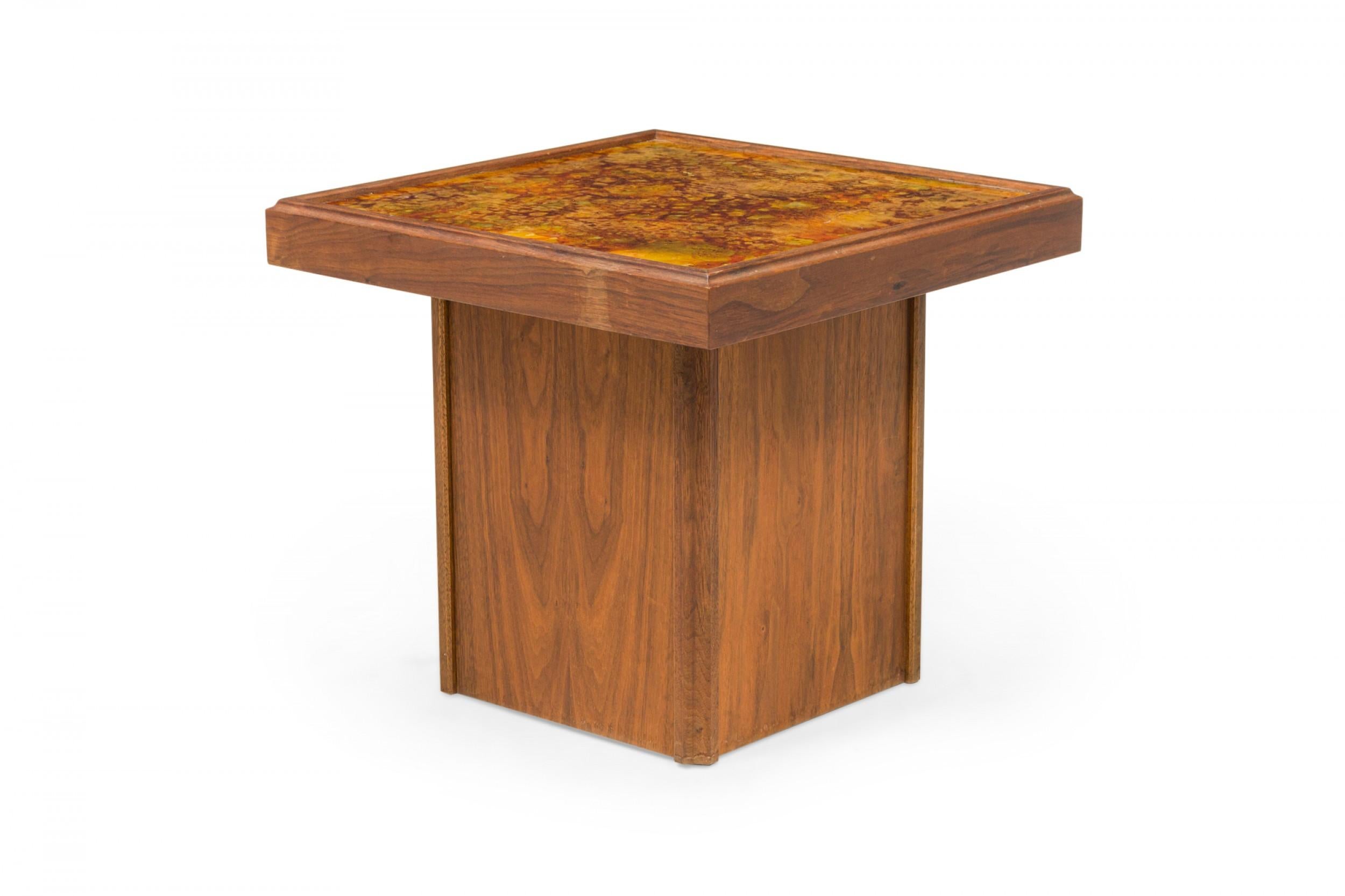 COPPIA di tavolini quadrati americani del Mid-Century con piani in vetro dipinto al contrario montati su una struttura in noce e sostenuti da una base quadrata più piccola in noce. (JOHN KEAL PER BROWN SALTMAN) (PREZZO IN COPPIA).