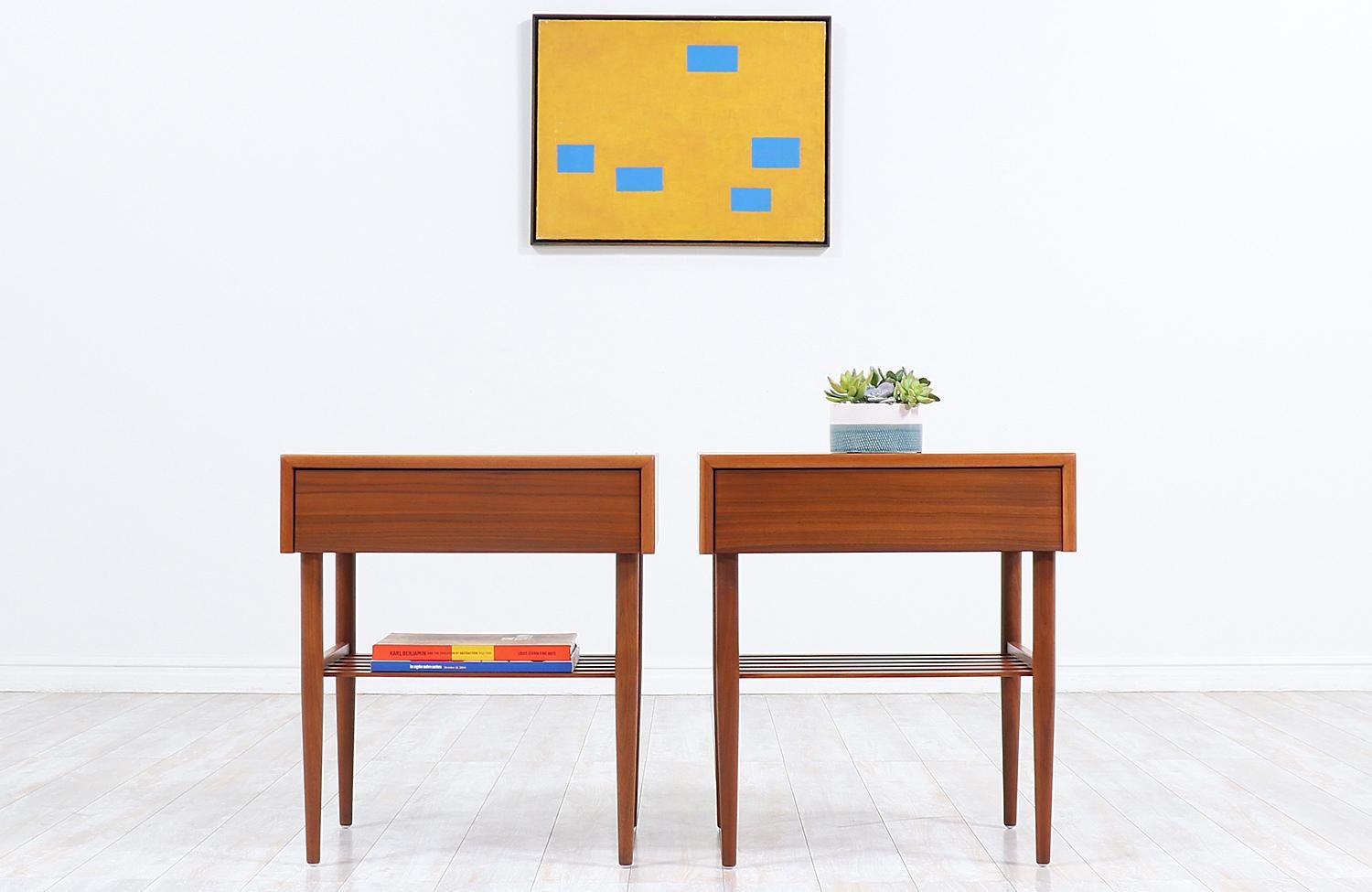 Spectacular pair of vintage nightstands designed by American designer John Keal in collaboration with California company, Brown Saltman, who operated in the city of Los Angeles in the 1950s. Our nightstands are crafted in warm walnut wood that