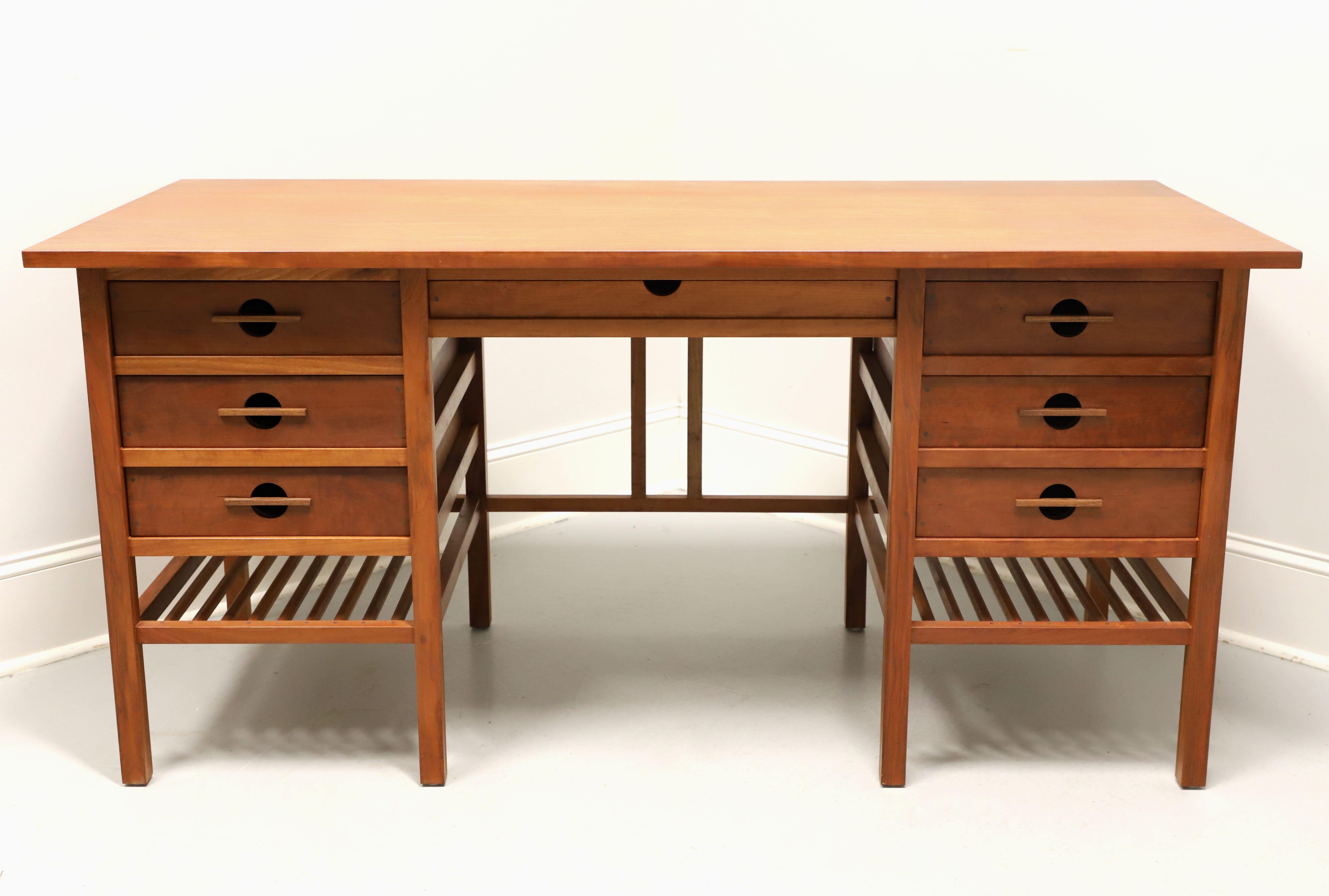 A Mission / Arts & Crafts style kneehole desk by John Kelly Furniture, the J-22A Secretary Desk, from their J1 Series. Solid black cherry with black walnut peg detailing to drawers, square edge overhanging top, signature exposed structural frame,