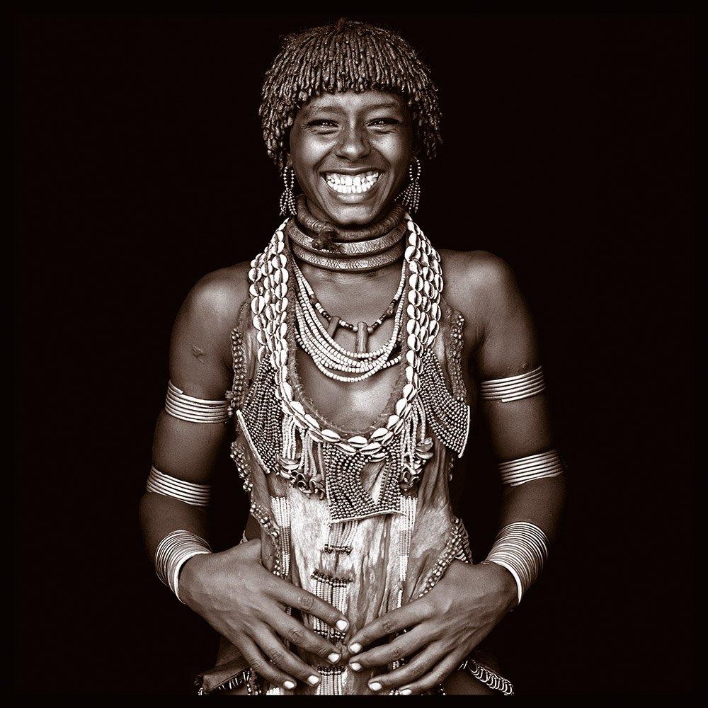 Ancho is a Hamer woman from the Omo Valley in Southern Ethiopia.  John met her on his first journey to the region in 2006.  Her portrait was featured on the front cover of a number of magazines and, on his return, he searched her out.  This image is