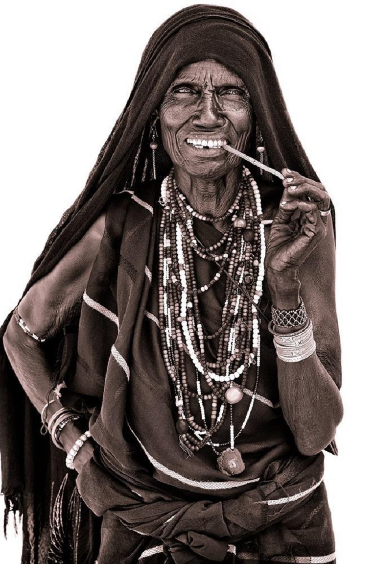 John Kenny met this Gabbra woman on the road to Kolal in Northern Kenya in 2019.

John uses simple natural light and builds primitive makeshift studios from locally acquired white sheets!  The suffuse light allows him to capture a remarkable level