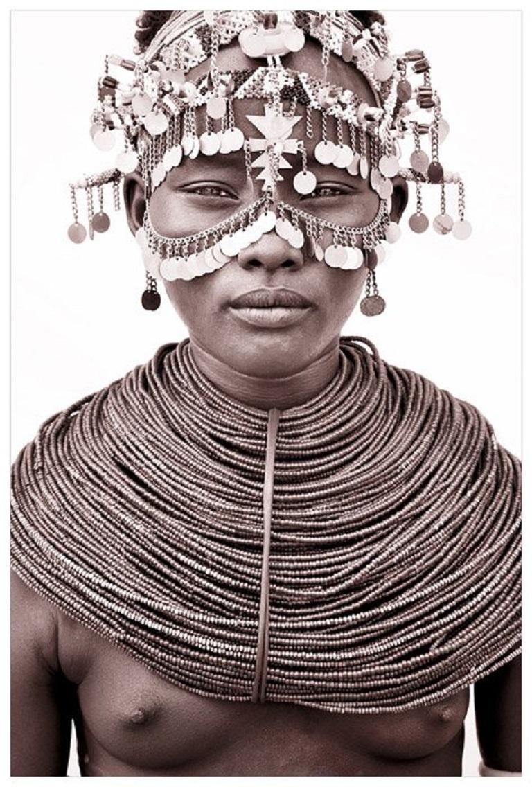 A Rendille girl in Kenya

A return to Kenya.  On this trip John took a different approach to lighting.  Building makeshift studios from locally acquired white sheets held up by four warriors and their spears!  The suffuse light allows John to