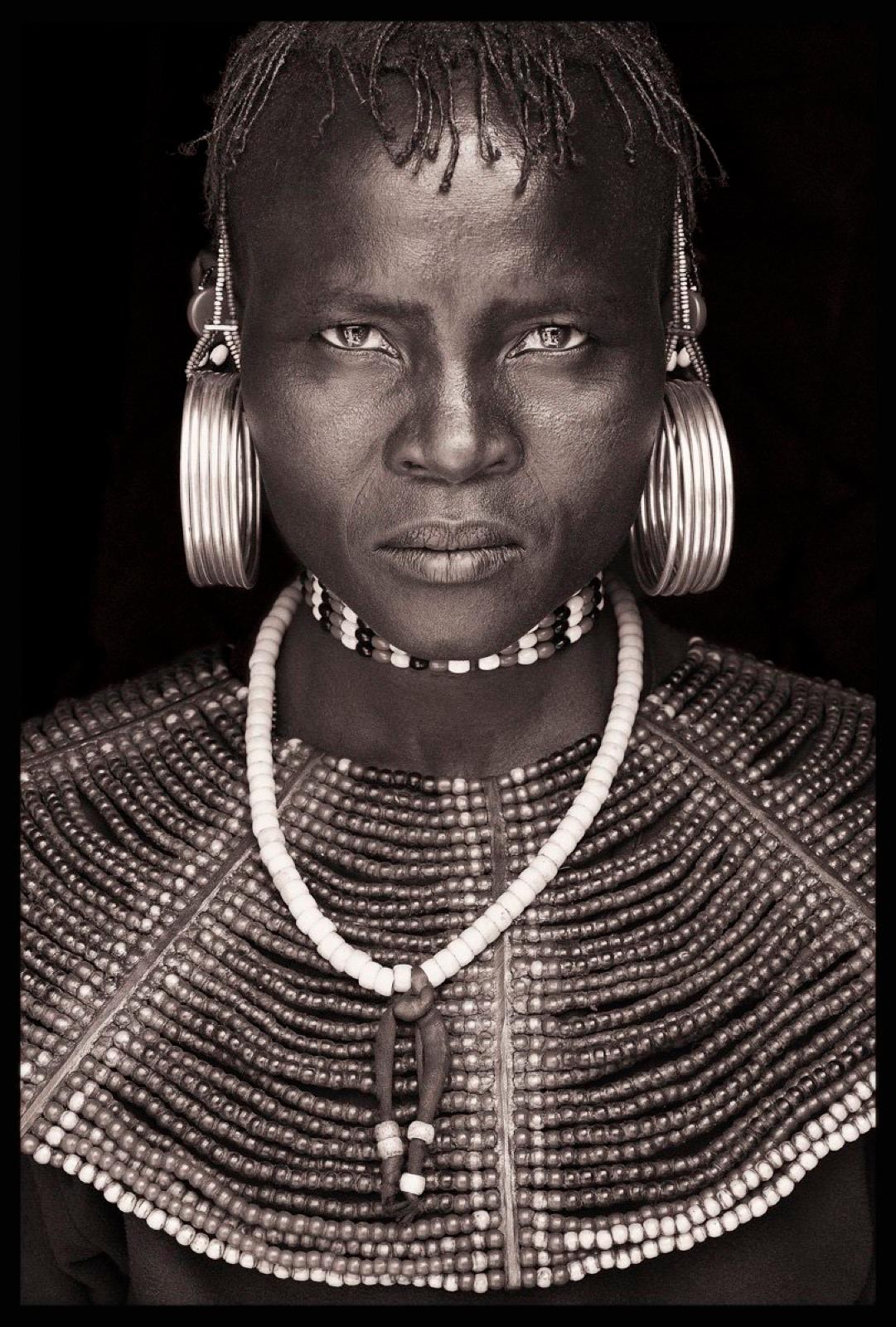 I came across the intense stare of this Pokot lady at a Friday market on a mountain summit in northern Kenya; it was the same market where I photographed a Samburu goat herder wrapped in blankets. The Pokot and Samburu are engaged in a constant