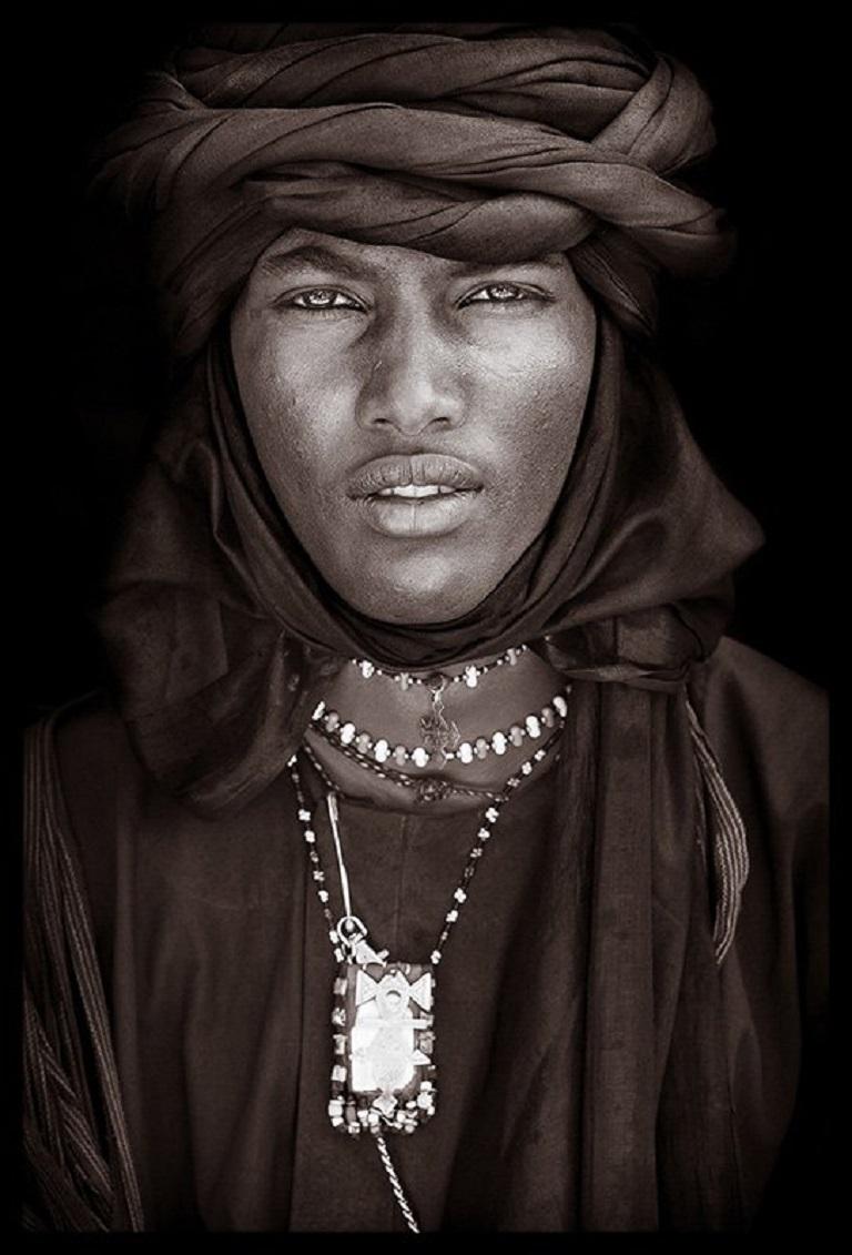 A Wodaabe man in Niger in 2009.

John Kenny’s work is all shot on location in some of the remotest corners of Africa. His images are all taken with natural light and his subjects in their day to day attire.

The C-type prints are mounted with an