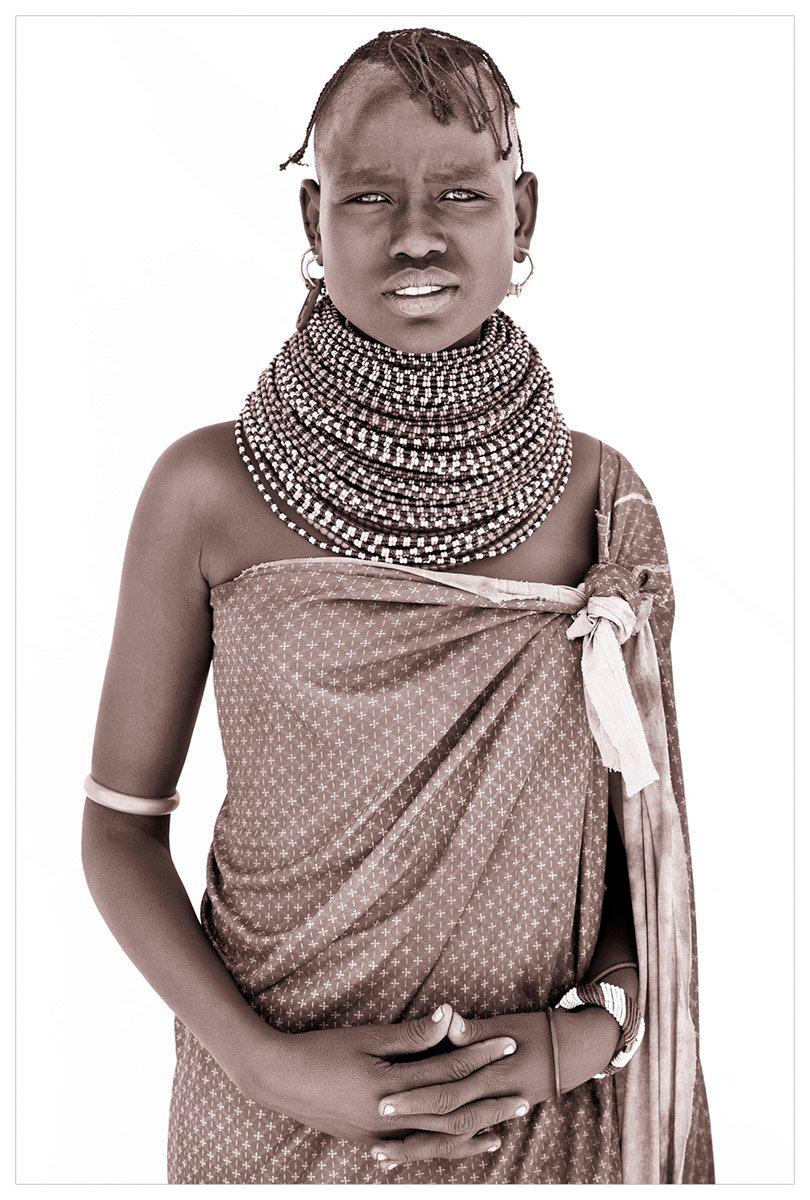 A girl of the Samburu

A return to Kenya.  On this trip John took a different approach to lighting.  Building makeshift studios from locally acquired white sheets held up by four warriors and their spears!  The suffuse light allows John to capture a