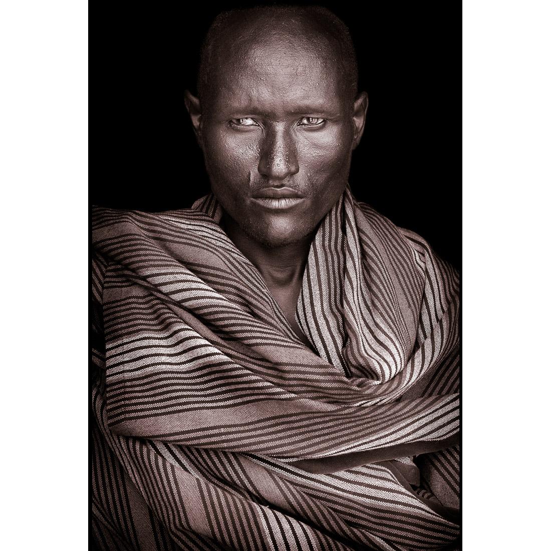 A portrait of Acuan, a Turkana man from northern Kenya in 2019.

John Kenny’s work is all shot on location in some of the remotest corners of Africa. His images are all taken with natural light and his subjects in their day to day attire.

The