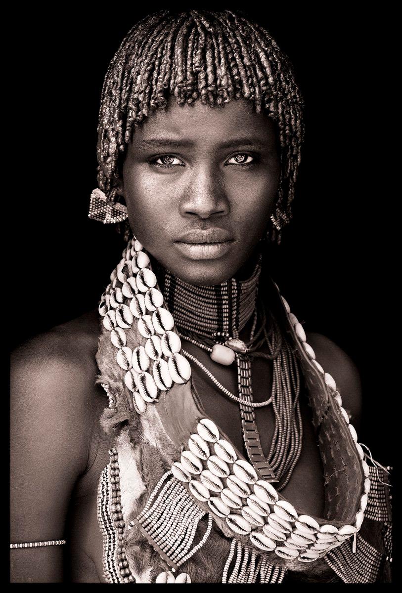 Assile was photographed at a weekly market in Key Afar in the Omo valley. Key Afar is on a hillside near the mountains, and attracts hundreds of Hamer, Banna and Tsemai in an immensely colourful gathering of people.

The market is divided between