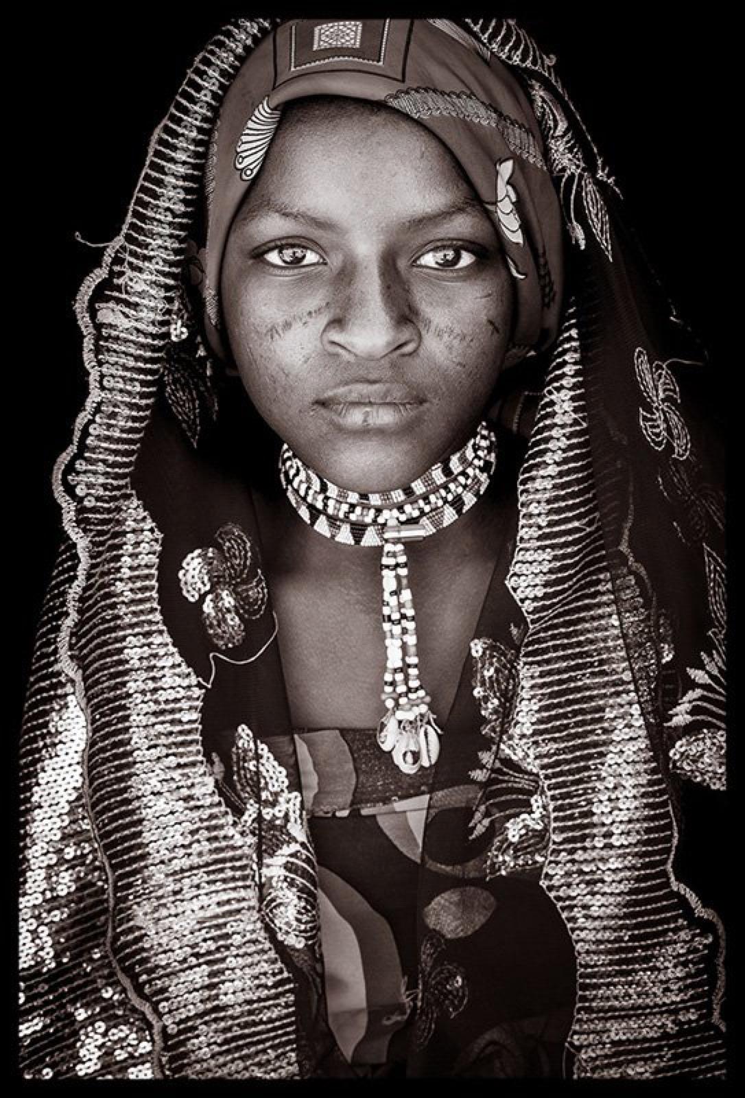 A young Fulani girl in Ethiopia.  The  Fulani have a nomadic lifestyle that sees them moving across the Sahel from Mali in the West to  Ethiopia in the East.
John Kenny’s work is all shot on location in some of the remotest corners of Africa. His