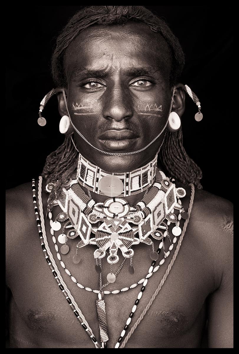 I met Lemoroko, a Rendille moran (warrior), in the southern reaches of the Rendille homeland, on the boundary of the neighbouring Samburu District. He had a striking, chiselled appearance, and vibrant blue eyes that seemed so incongruous next to his