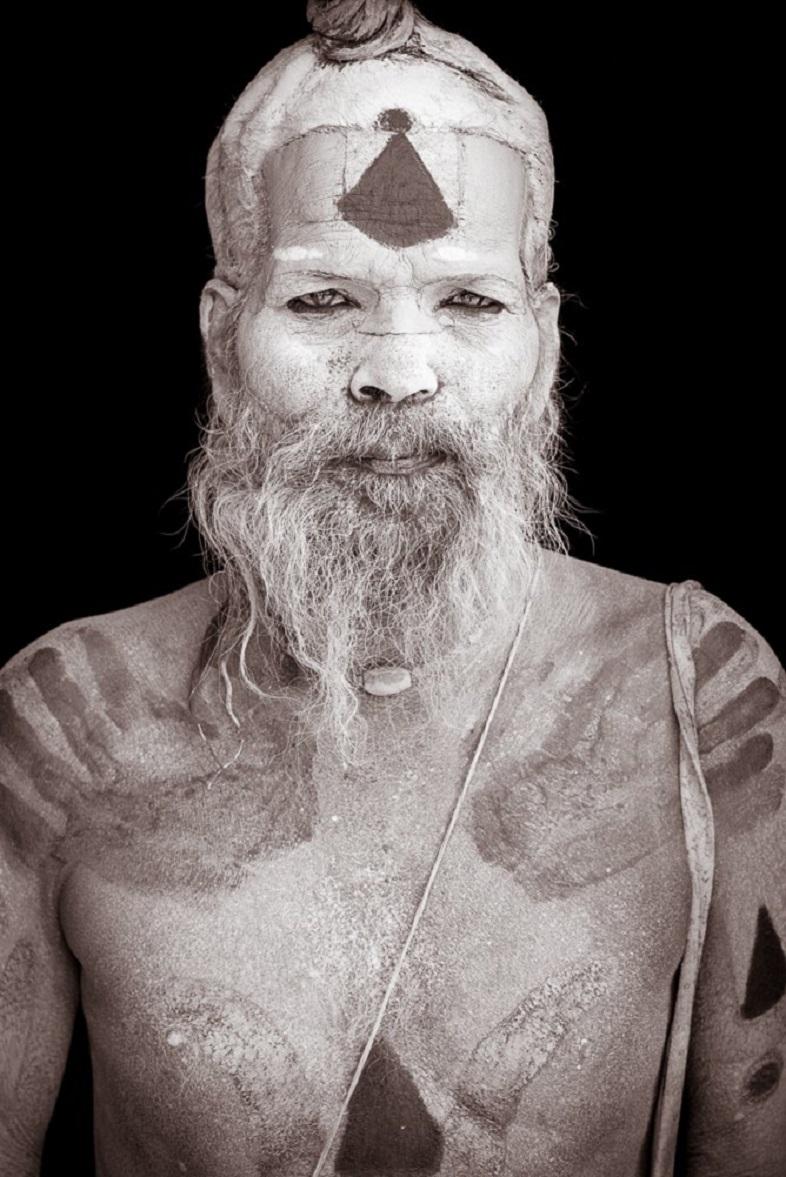 This portrait of Loha, a ‘Naga’ sadhu, was taken in Pashupatinath, one of Hinduism’s holiest sites.   Lord Pashupatinath is a manifestation of Lord Shiva and the name translates to ‘protector of the animals’.   Naga sadhus cover themselves in  ash