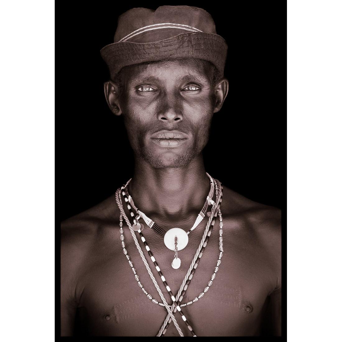 A portrait of Ltailson, a Samburu man from northern Kenya in 2019.

John Kenny’s work is all shot on location in some of the remotest corners of Africa. His images are all taken with natural light and his subjects in their day to day attire.

The