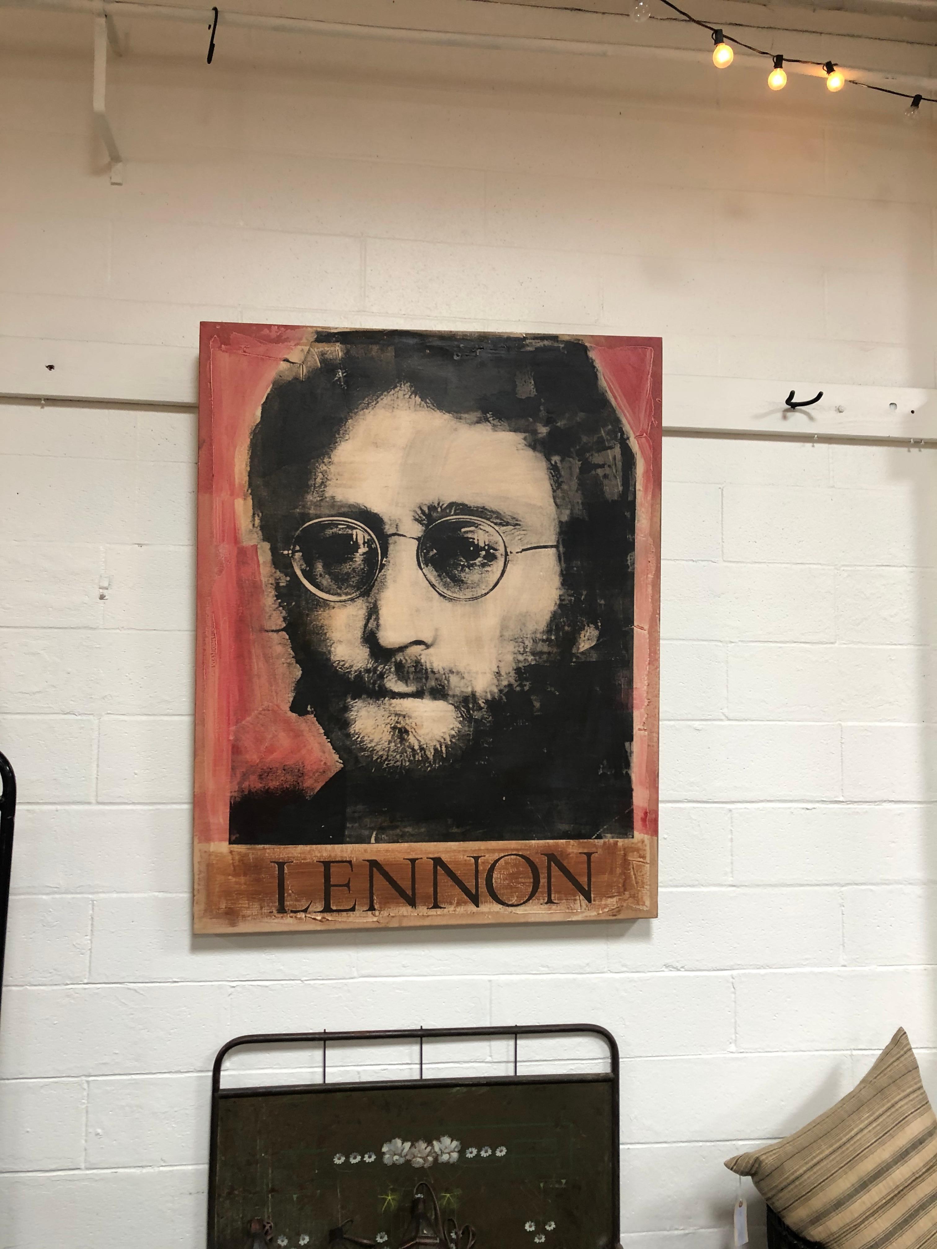 Large artwork piece featuring John Lennon on painted canvas. Red, black, and orange color scheme.