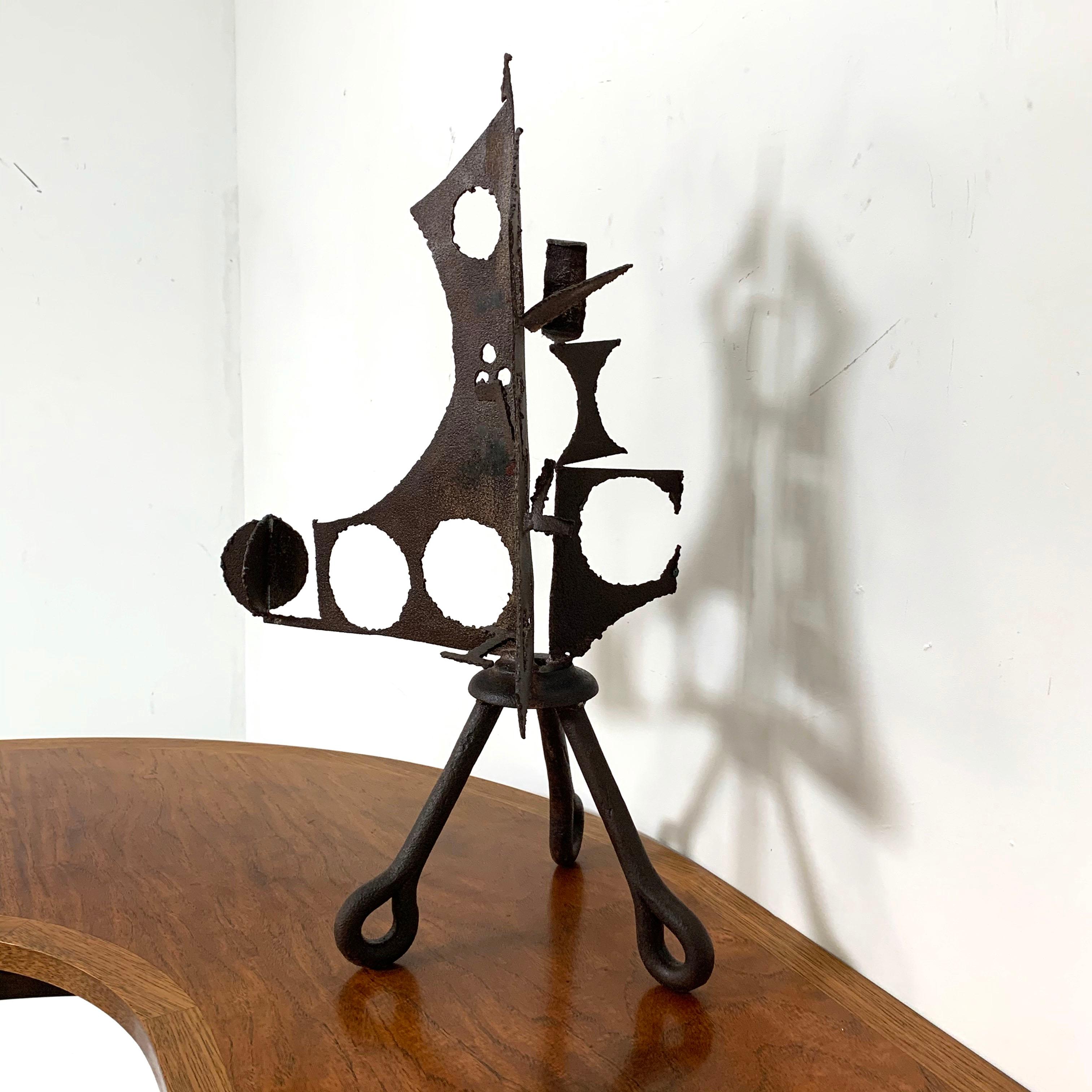 A welded steel sculpture by artist John Livermore of Acton, MA, circa 1970. Torch cut corten steel with tripod legs of castoff ring bolt plugs from the nearby Harris Granite Quarry. Livermore and his wife Elaine were well known artists in this