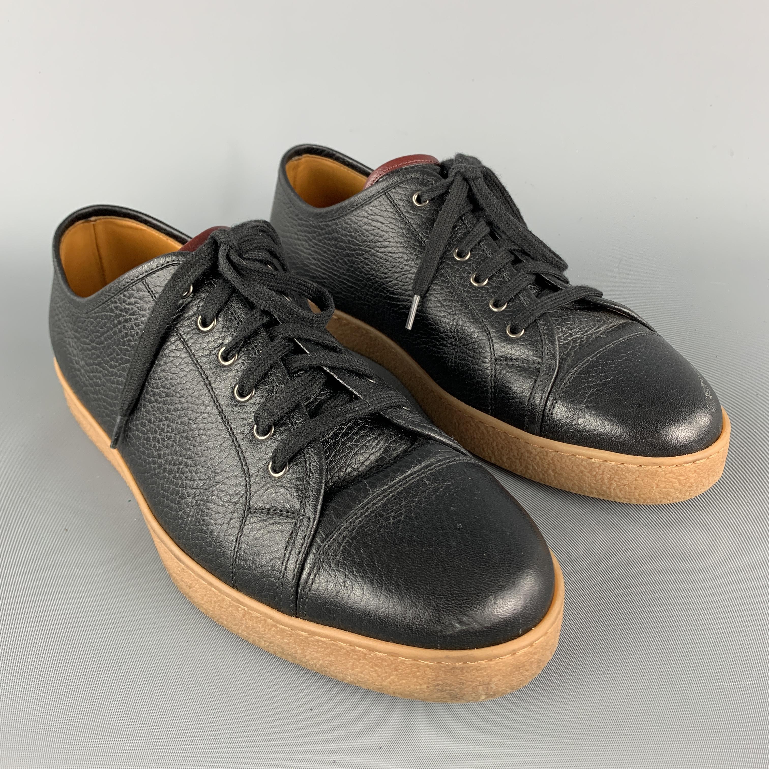 JOHN LOBB Sneakers comes in a black solid textured leather material, featuring a cap toe, a rubber sole, lace up. Made in Italy.

Excellent Pre-Owned Condition.
Marked: UK 7 

Outsole: 11 x 4 in.