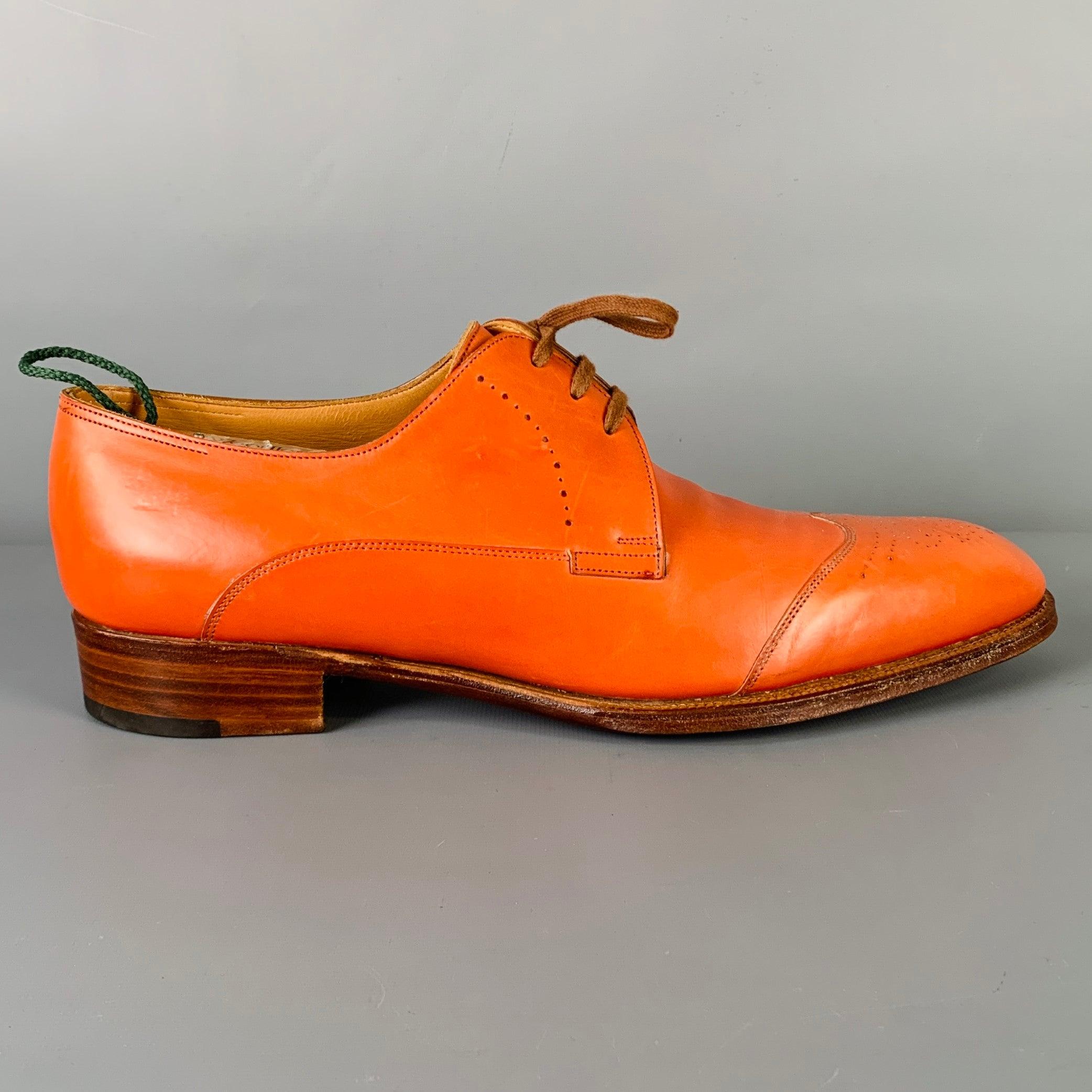 JOHN LOBB dress shoes
in an orange leather fabric featuring a perforated derby style, wing tip, and lace-up closure. Made in England.Excellent Pre-Owned Condition. 

Marked:   AINTREE 8.5 E11OSOutsole: 11.75 inches  x 4 inches 
  
  
 
Sui Generis