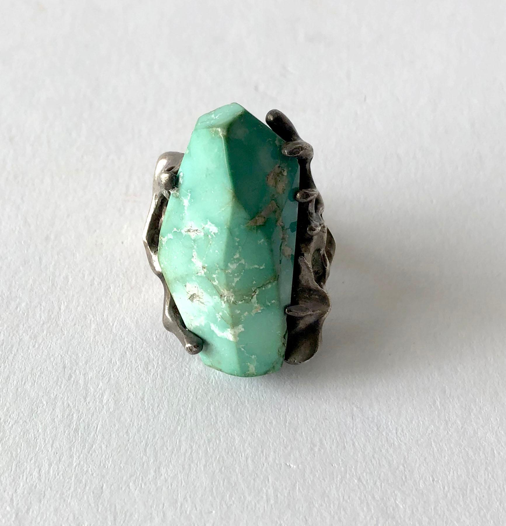 Faceted turquoise and sterling silver ring made by John M. Morgan of Ellensburg, Washington.   Ring is a finger size 7 and retains its natural, warm patina.  Unsigned.  In very good vintage condition.